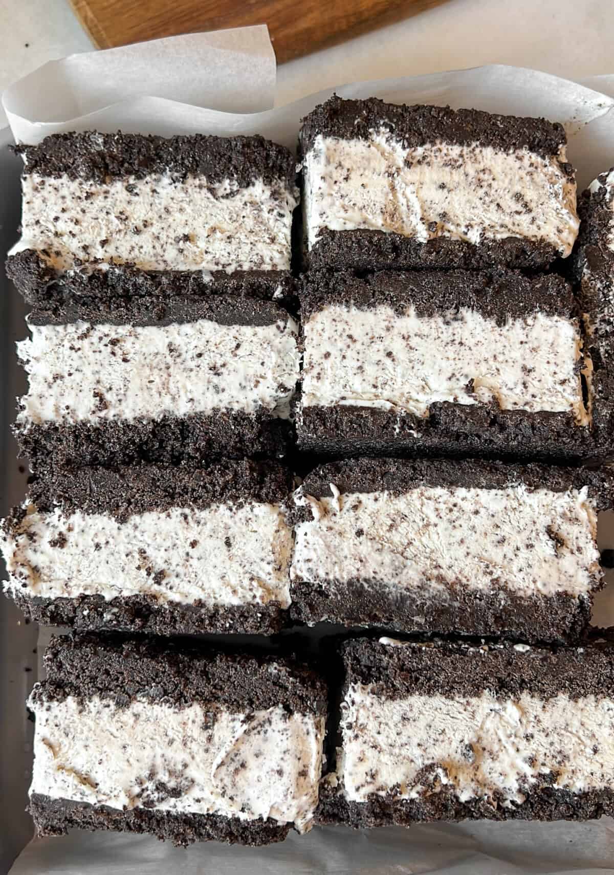 Oreo ice cream sandwiches stacked side by side in a pan