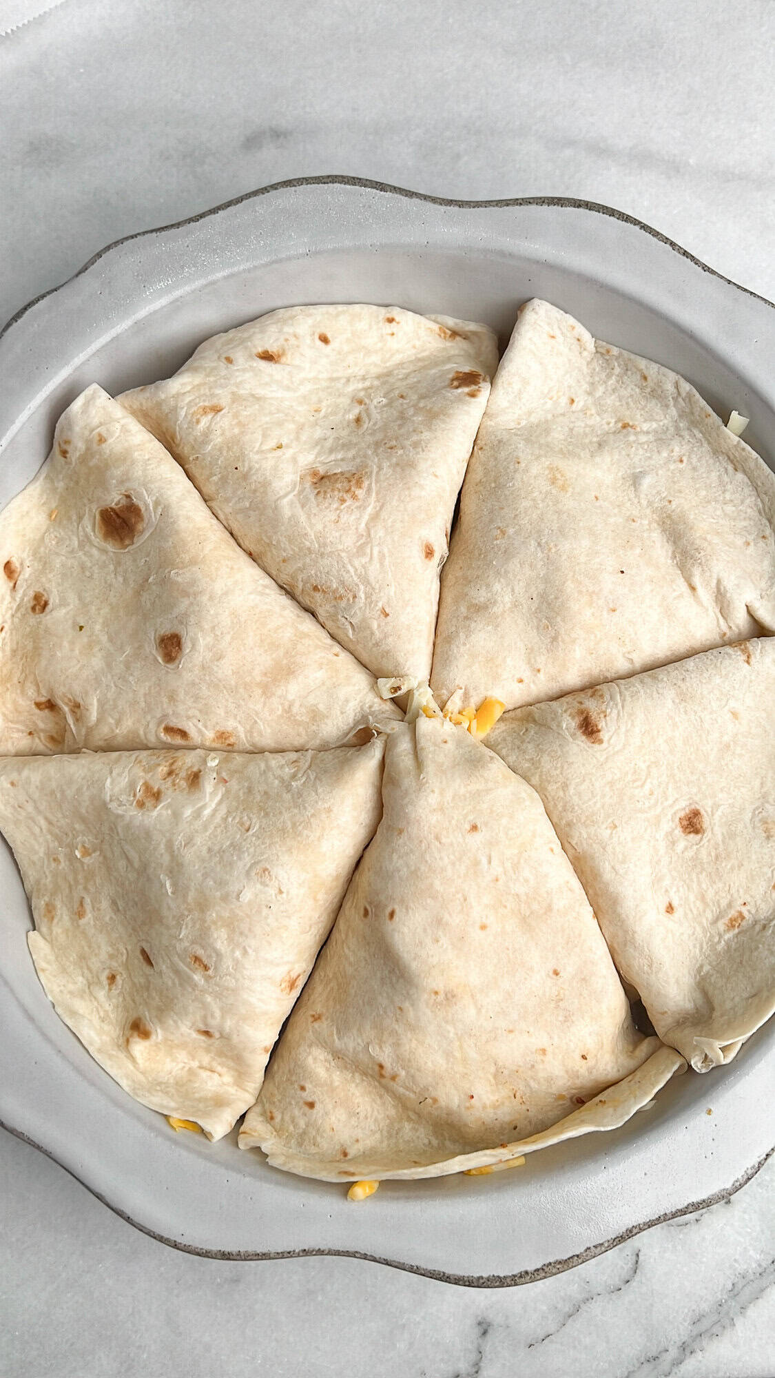 arrange tortilla triangles into a pan like a pizza
