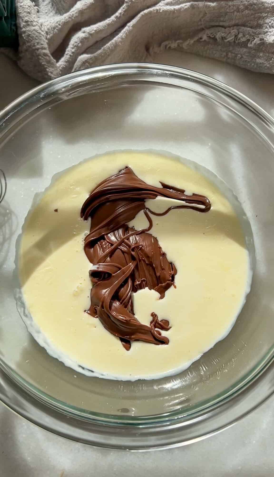 Heavy cream and Nutella in a bowl