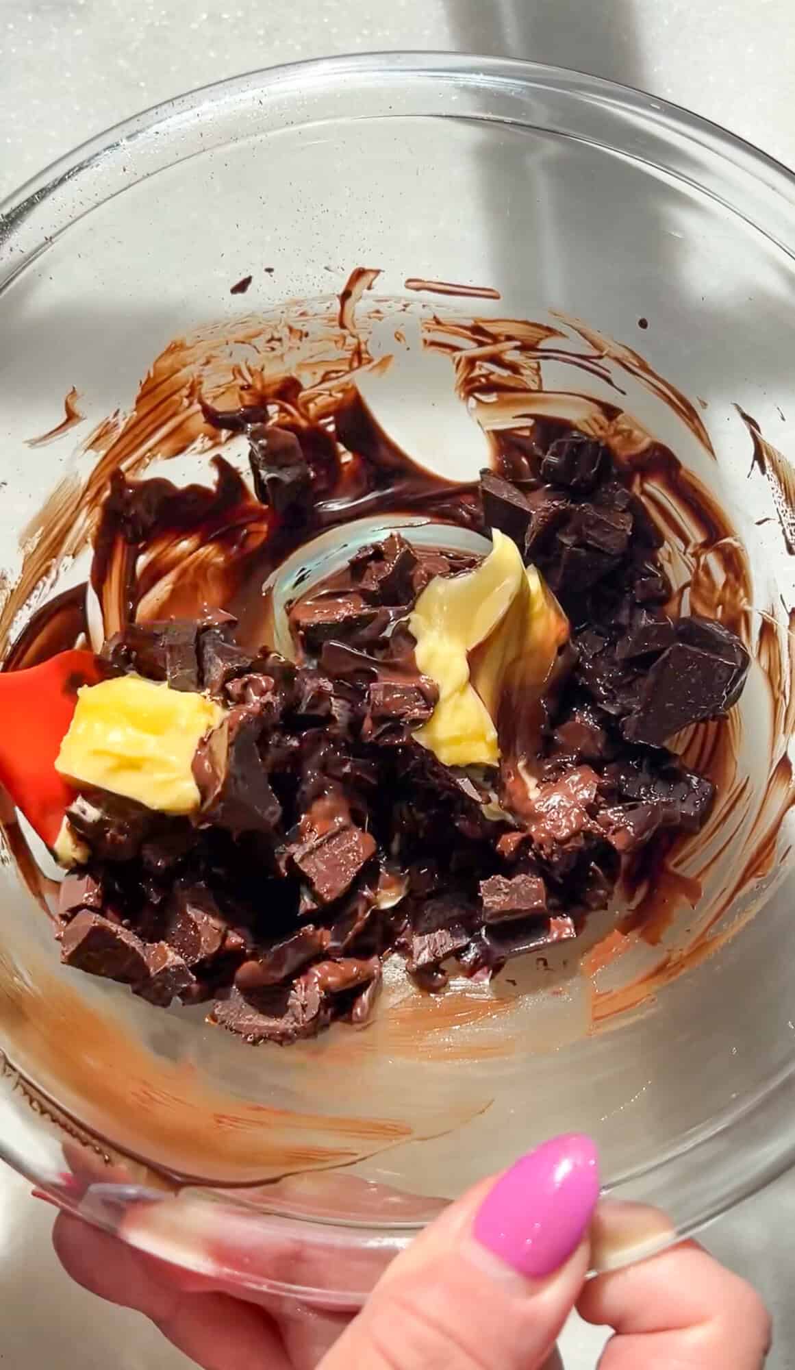 Partially melted chocolate and butter in a bowl