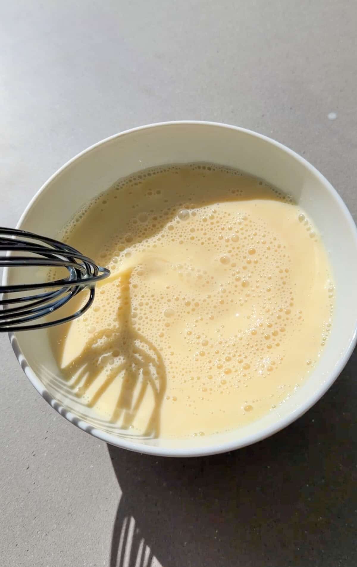 beating eggs, milk, and vanilla until frothy