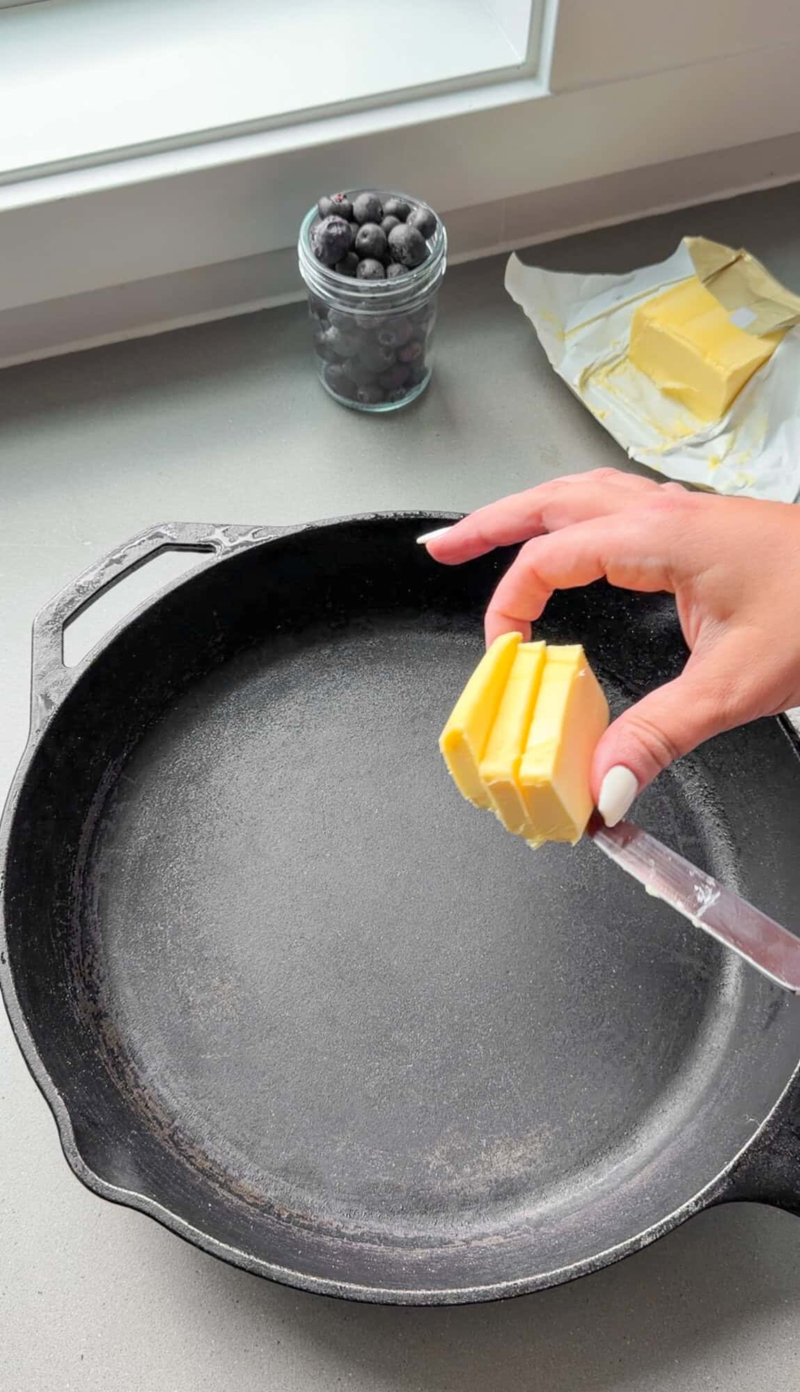 Adding butter into the cast-iron skillet
