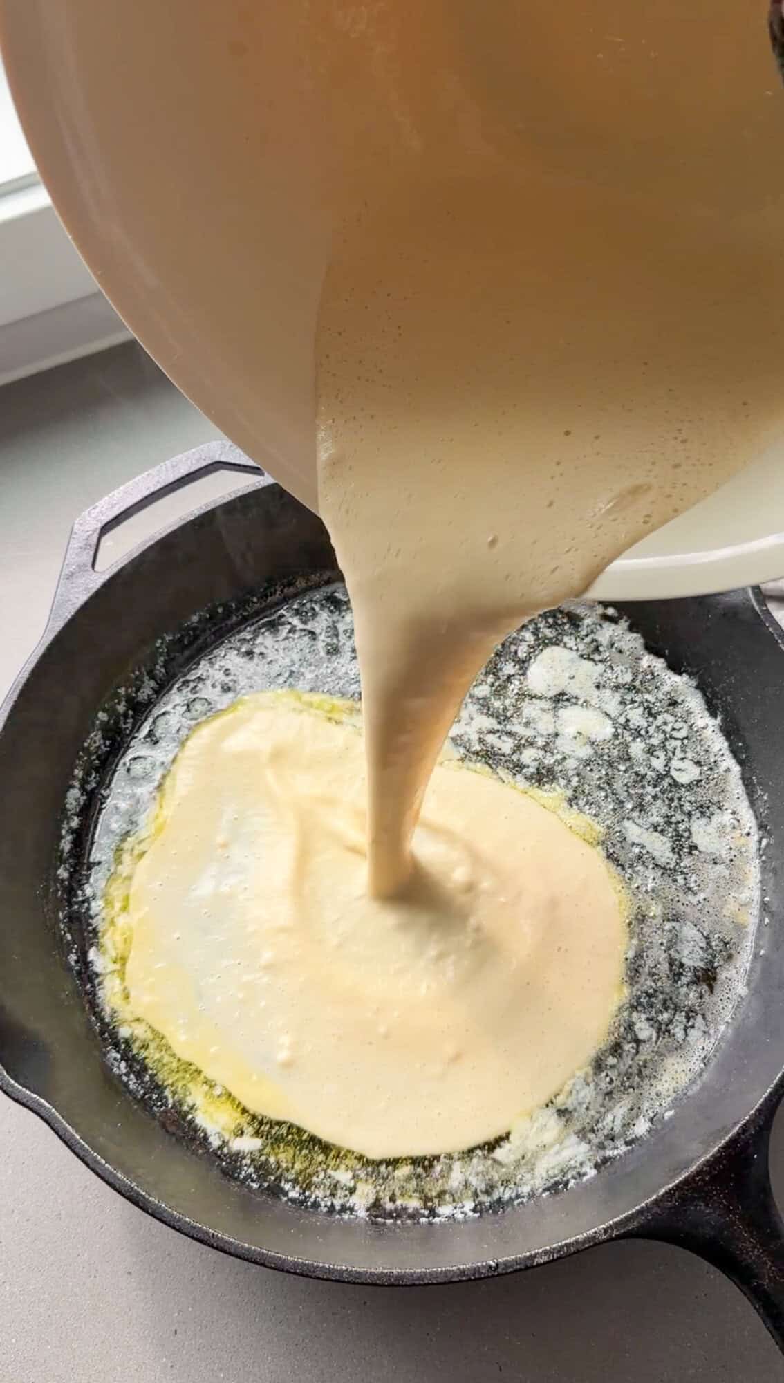 pouring batter into the sizzling butter