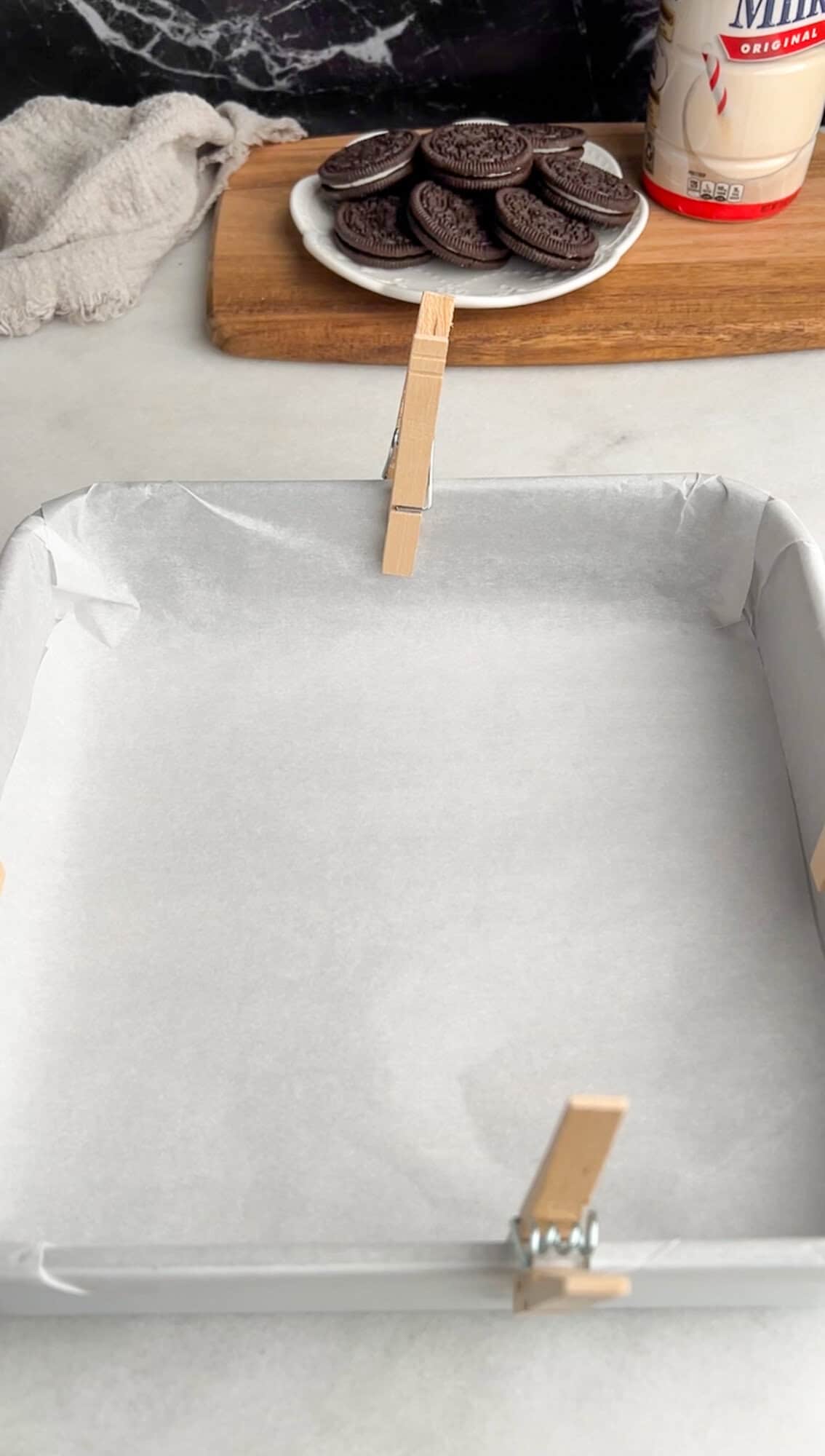 lining a pan with parchment paper and clothespins