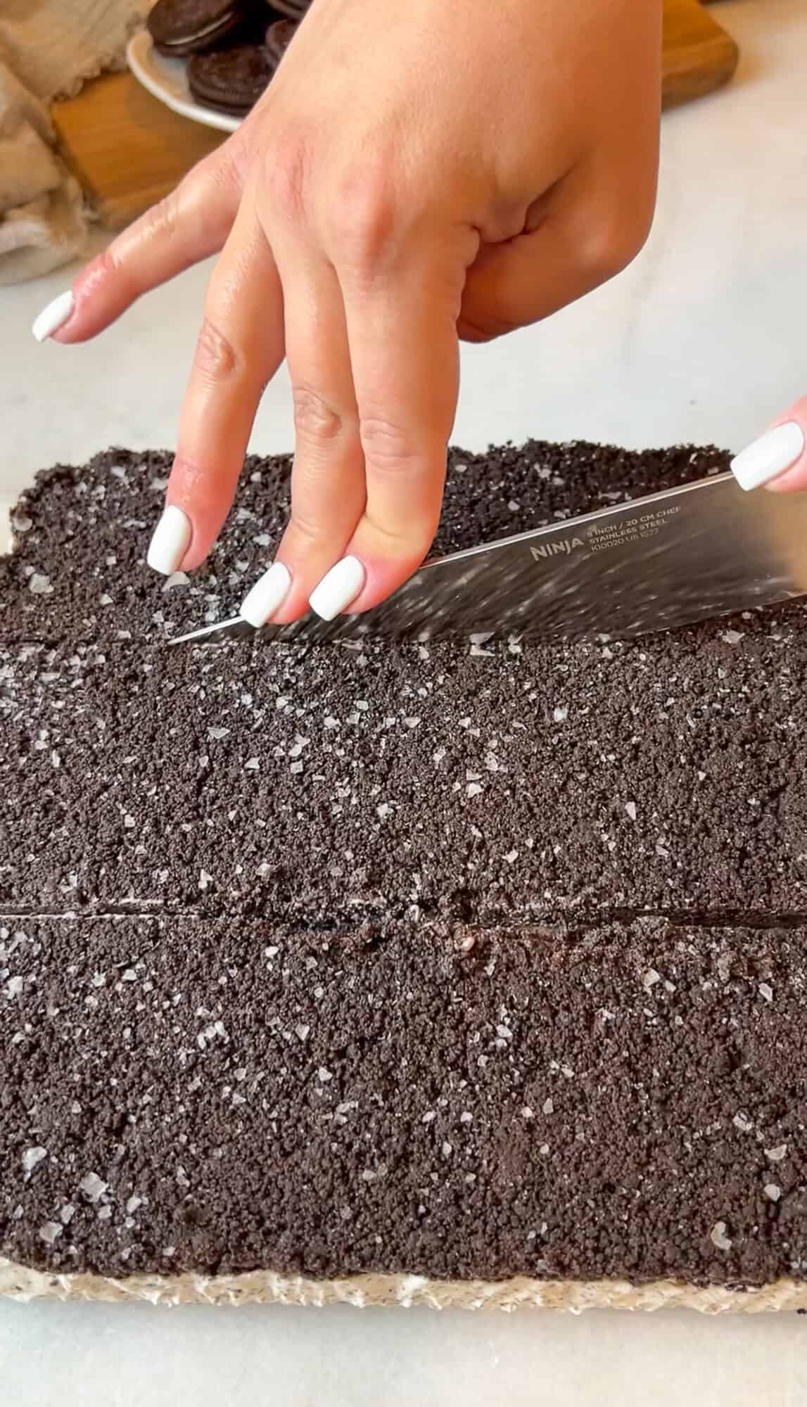 slicing the oreo ice cream sandwiches
