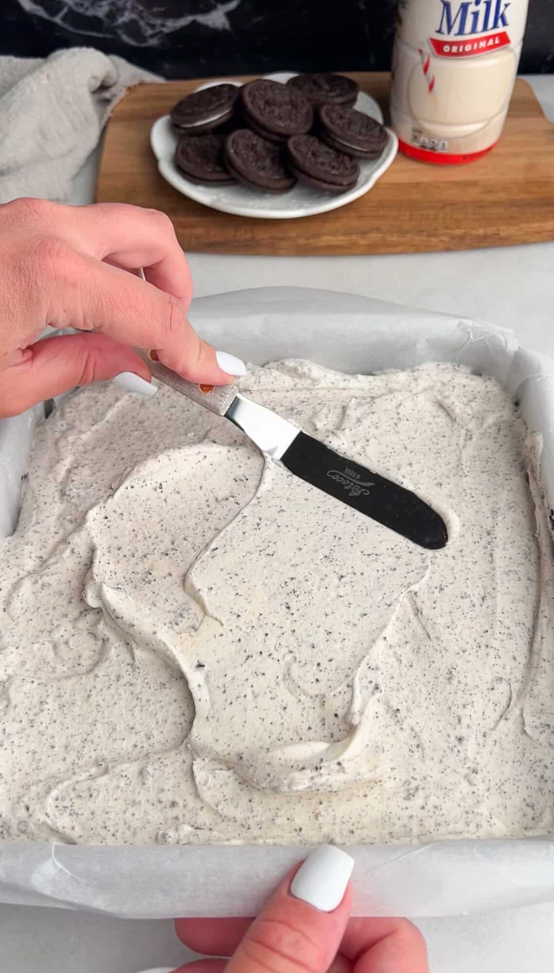 spreading cookies and cream ice cream filling layer