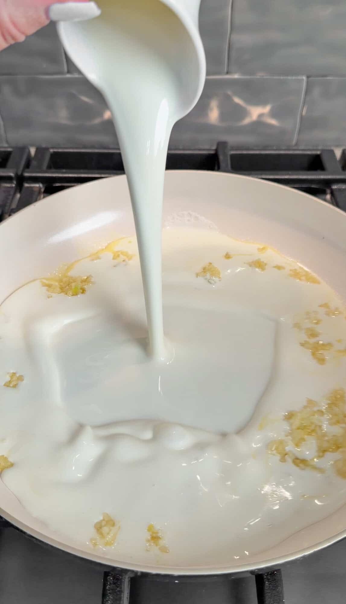 adding cream into the pan sauce