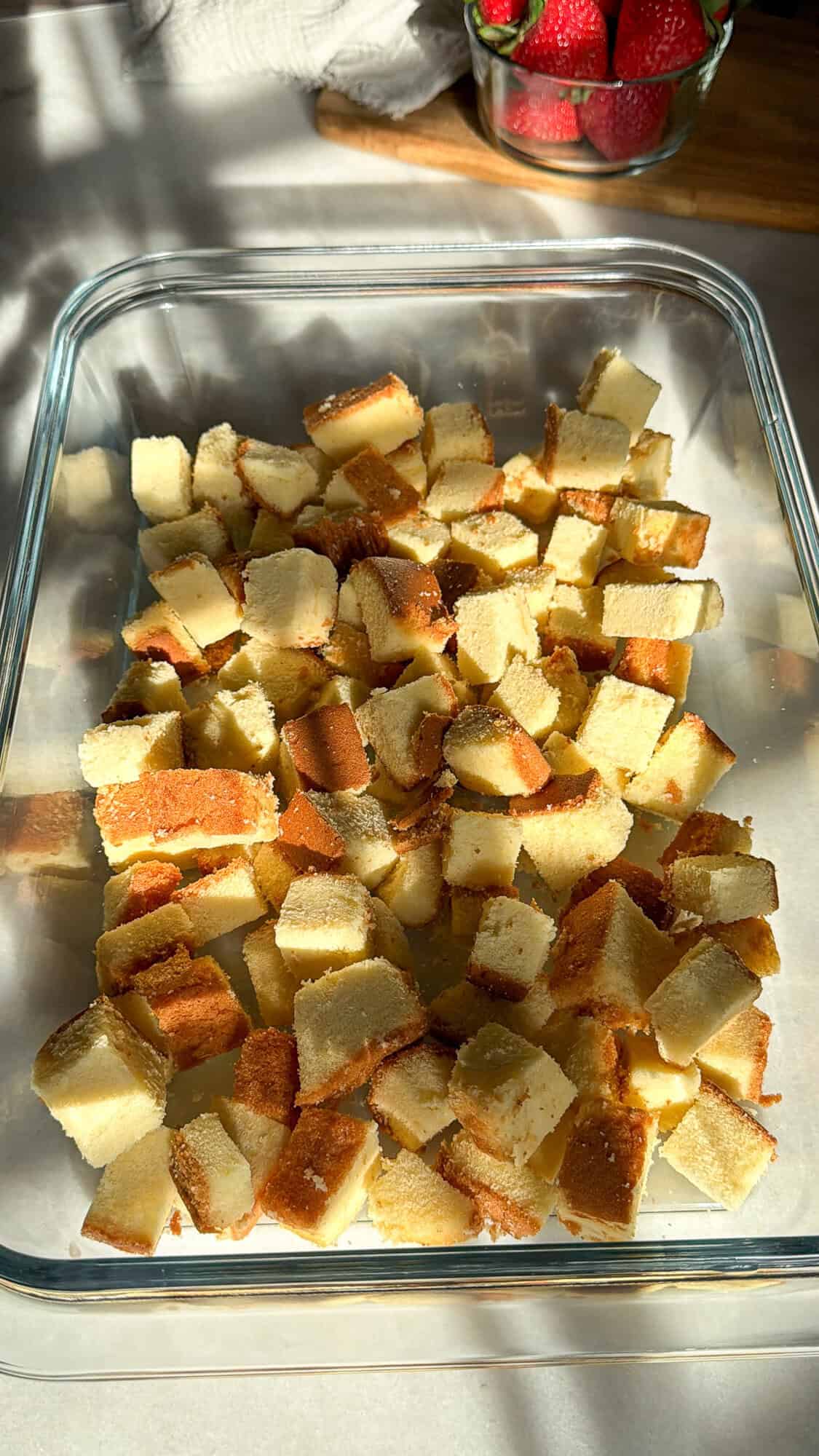 adding the pound cake layer for strawberry shortcake cheesecake