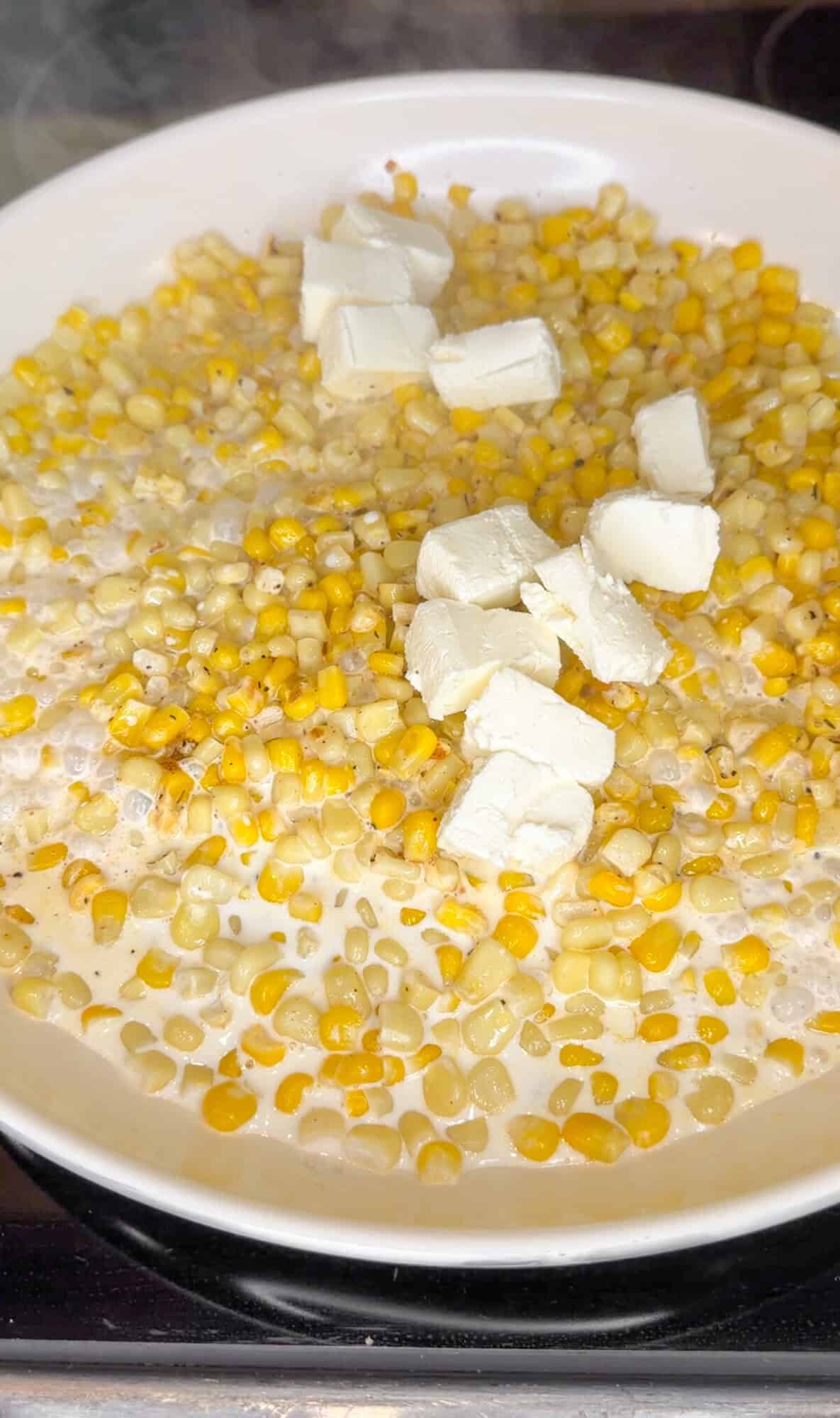 adding cream cheese and half and half to corn dip