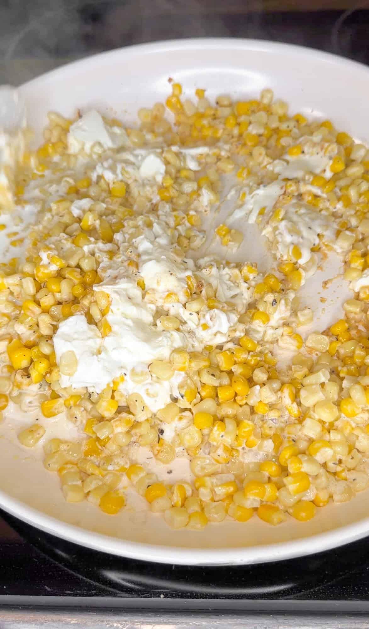 stirring in softened cream cheese to corn dip