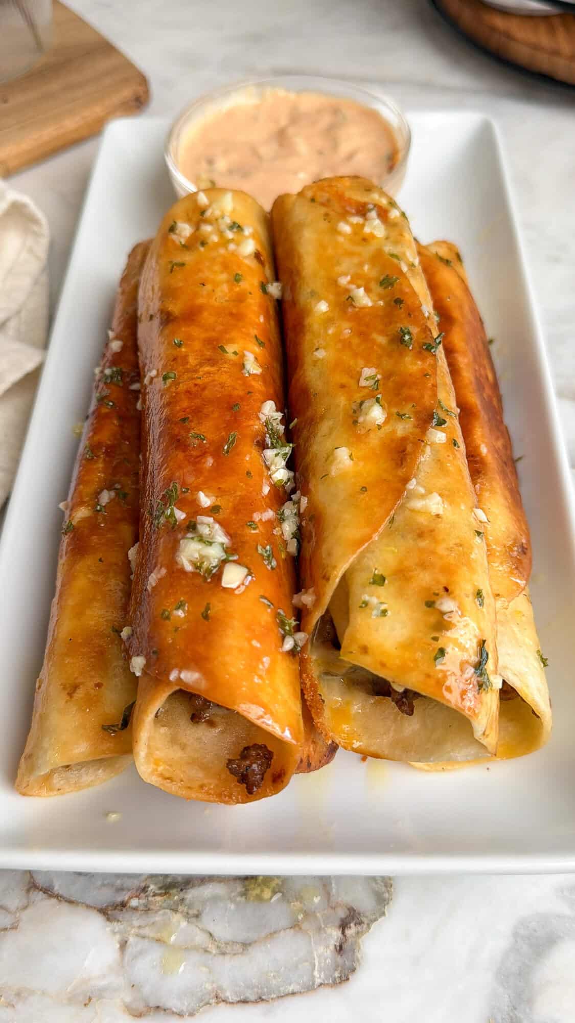 cheeseburger taquitos on a plate