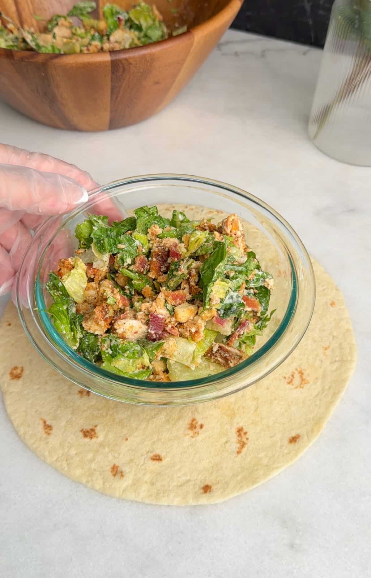 assembling chicken caesar wrap