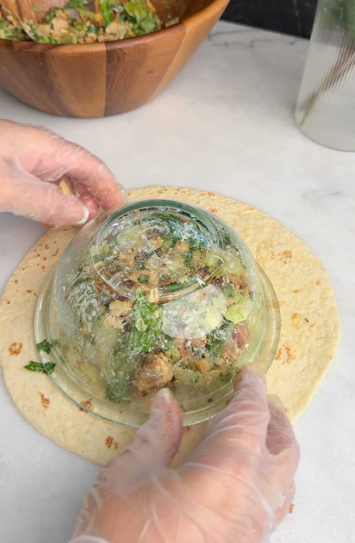 assembling chicken caesar wrap