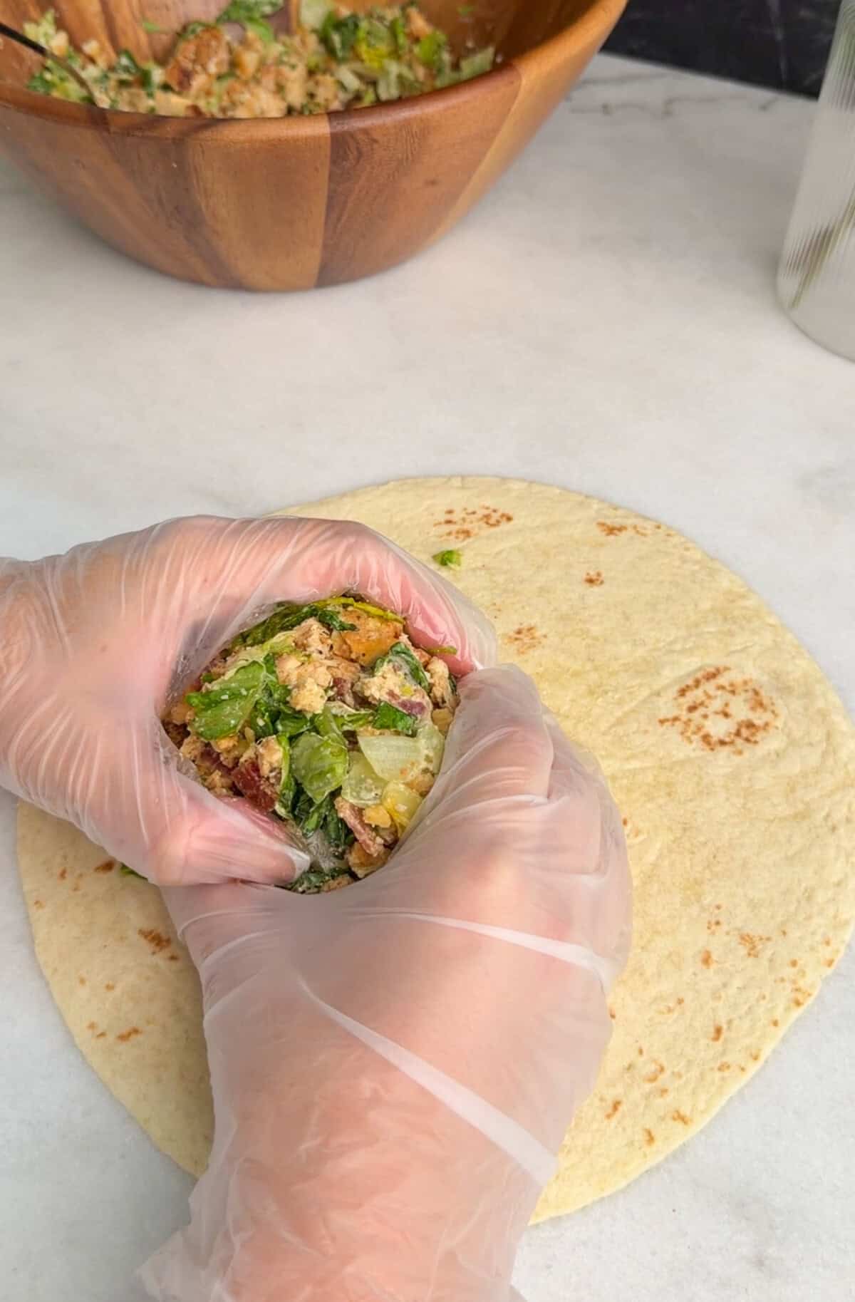 assembling chicken caesar wrap