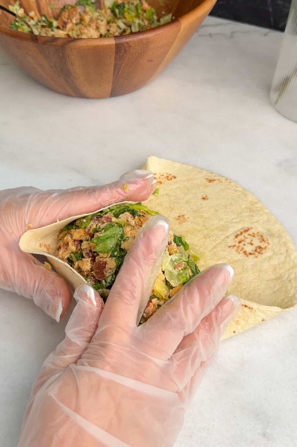 assembling chicken caesar wrap