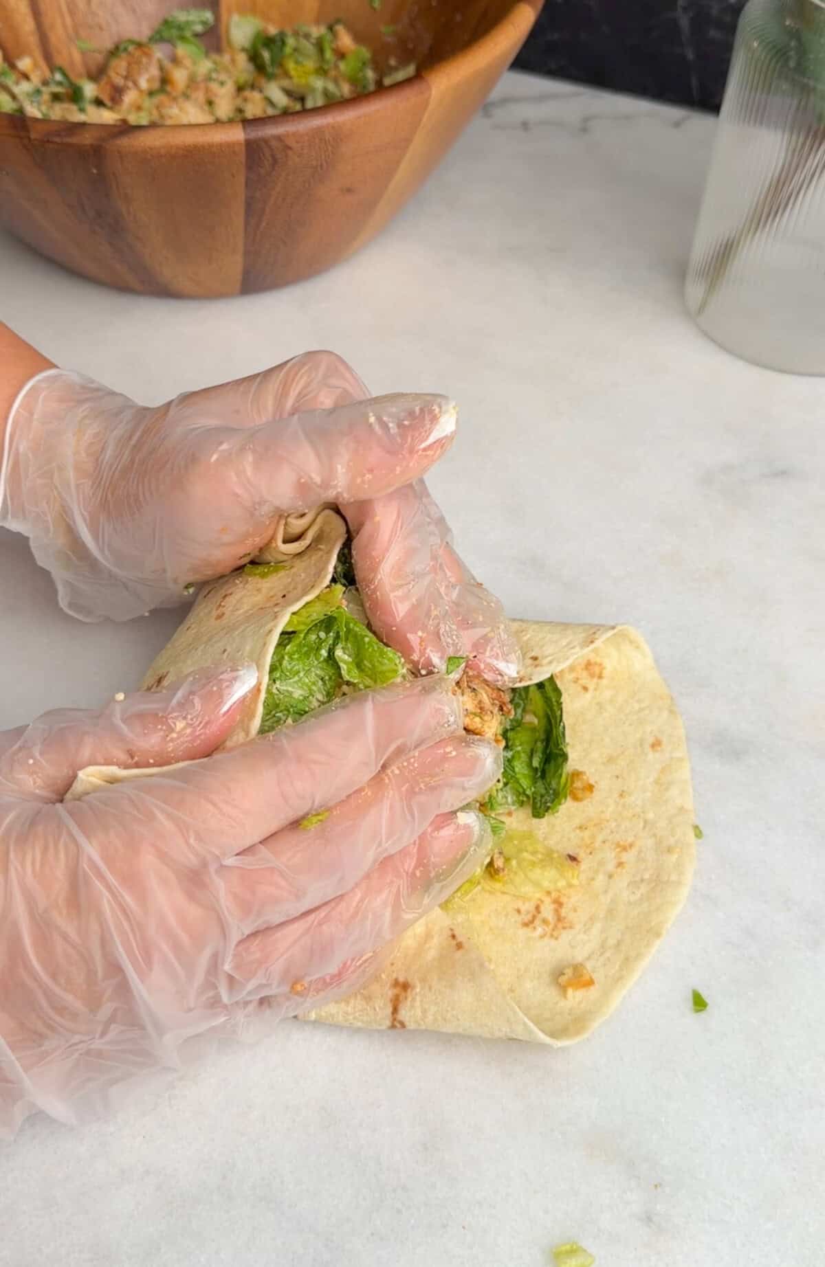 assembling chicken caesar wrap