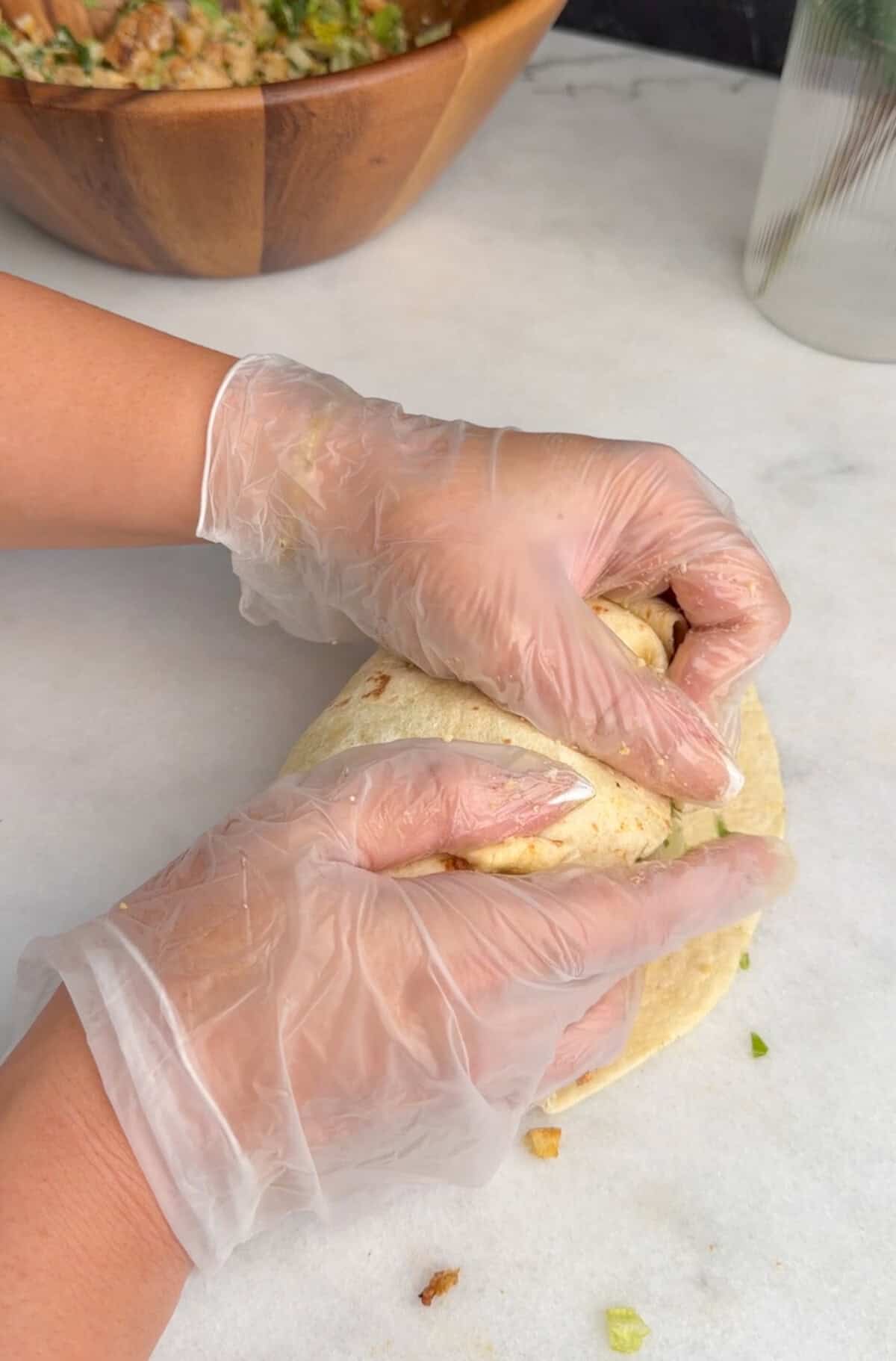 assembling chicken caesar wrap
