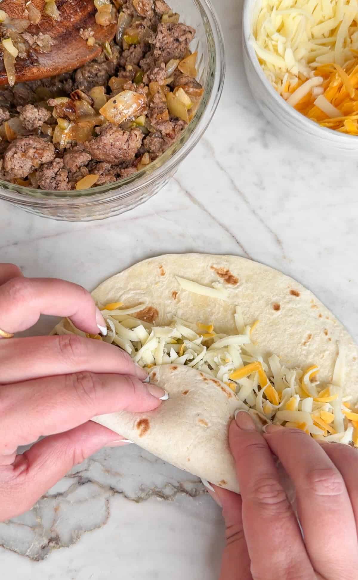 Rolling cheeseburger taquitos