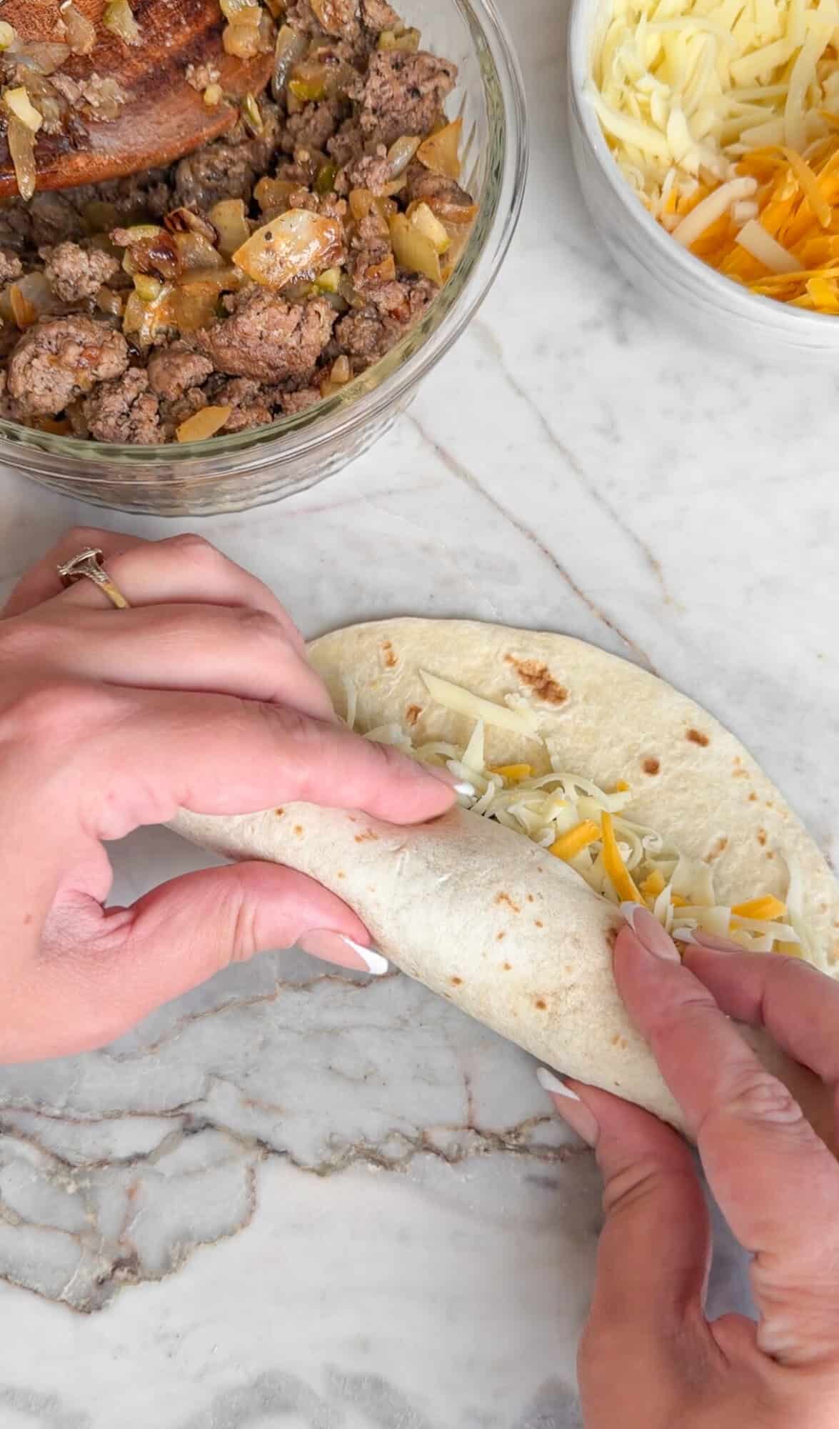 Rolling cheeseburger taquitos