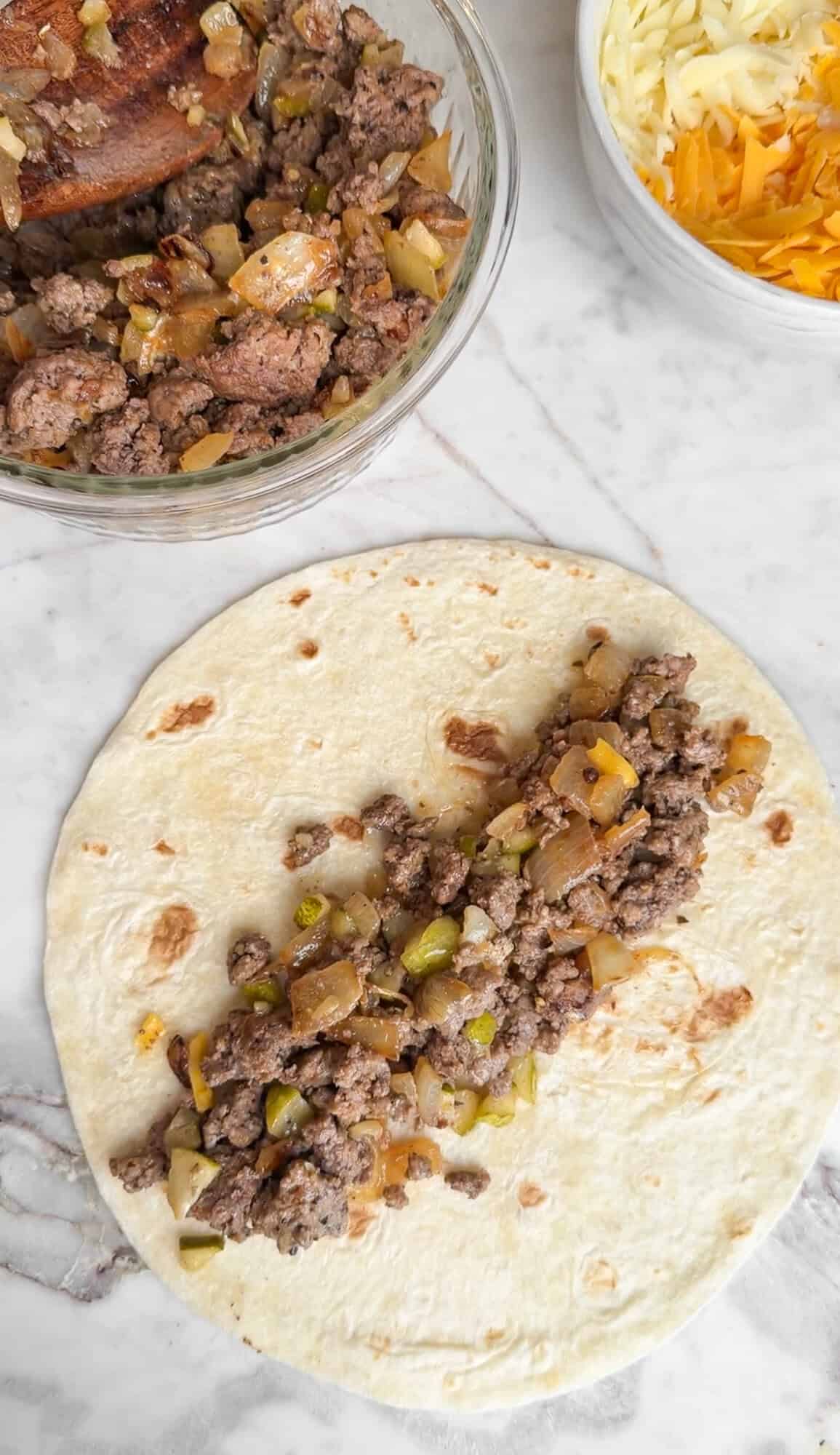 assembling cheeseburger taquitos