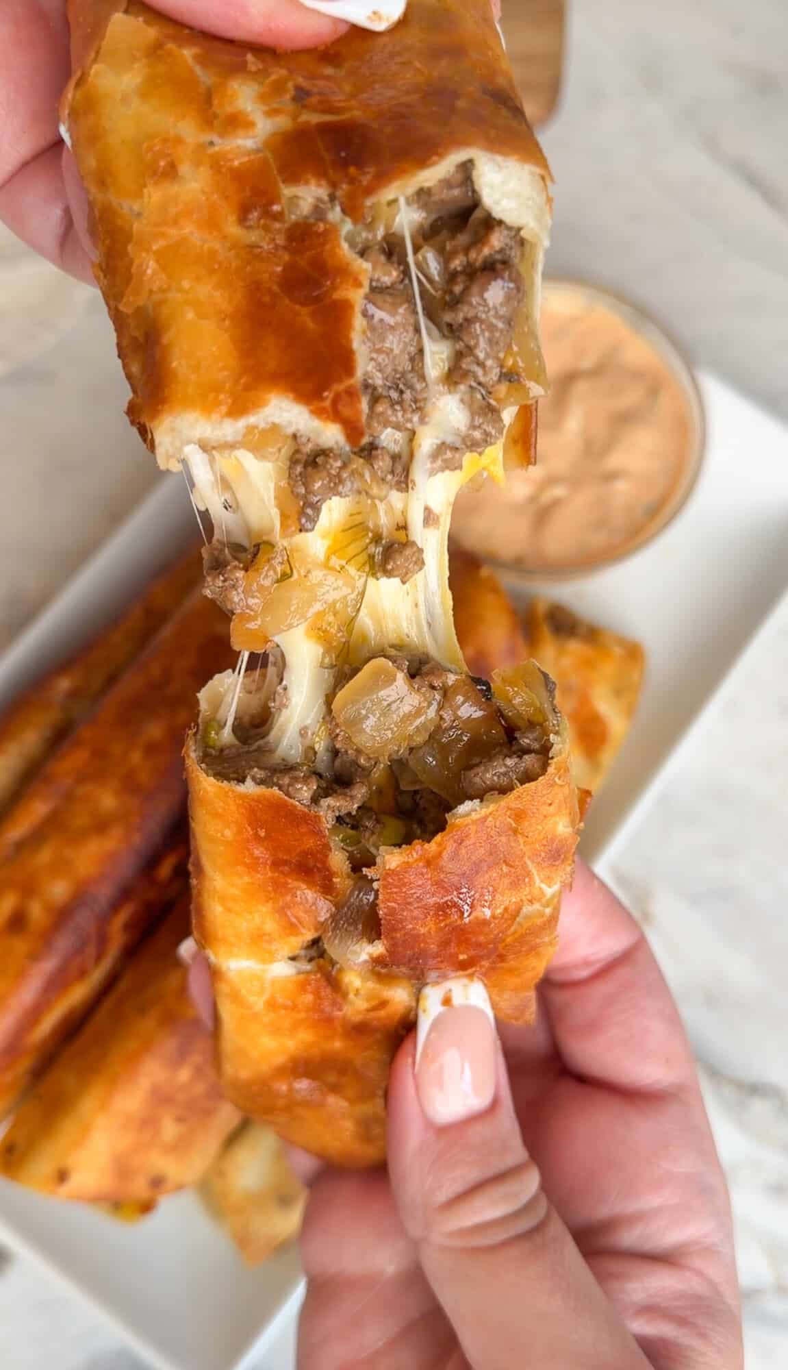 pulling apart a warm cheeseburger taquito