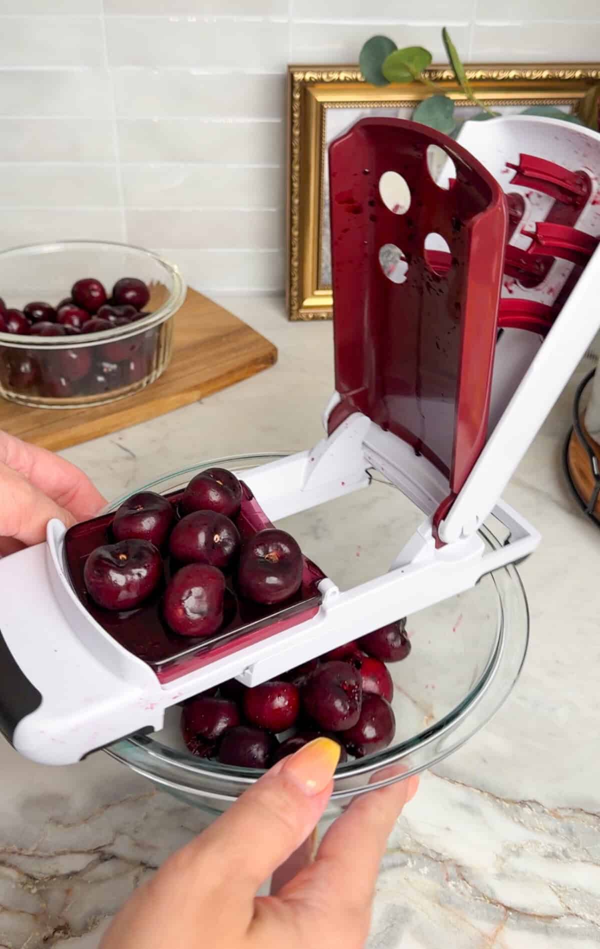 pitting the cherries for creamy cherry limeade
