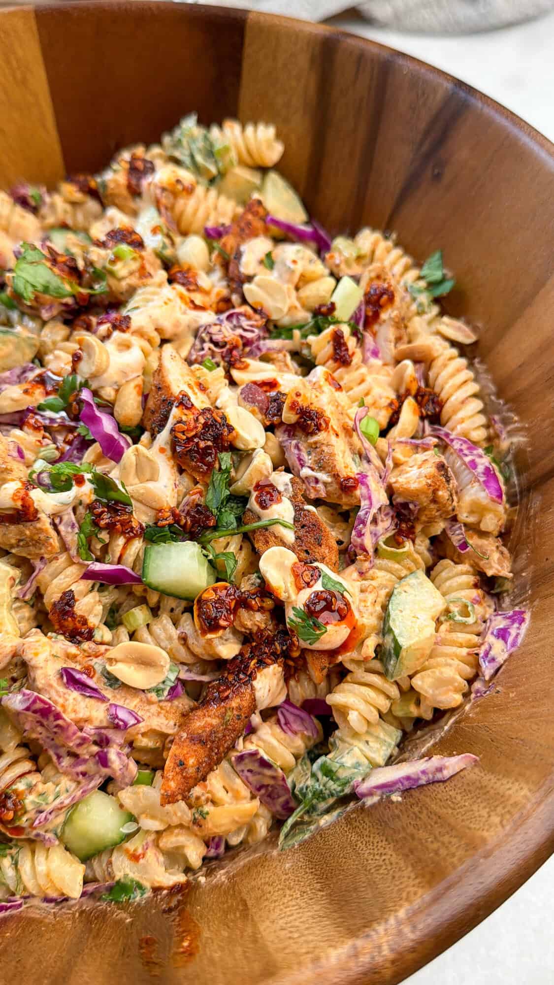 chili oil pasta salad in a wooden bowl