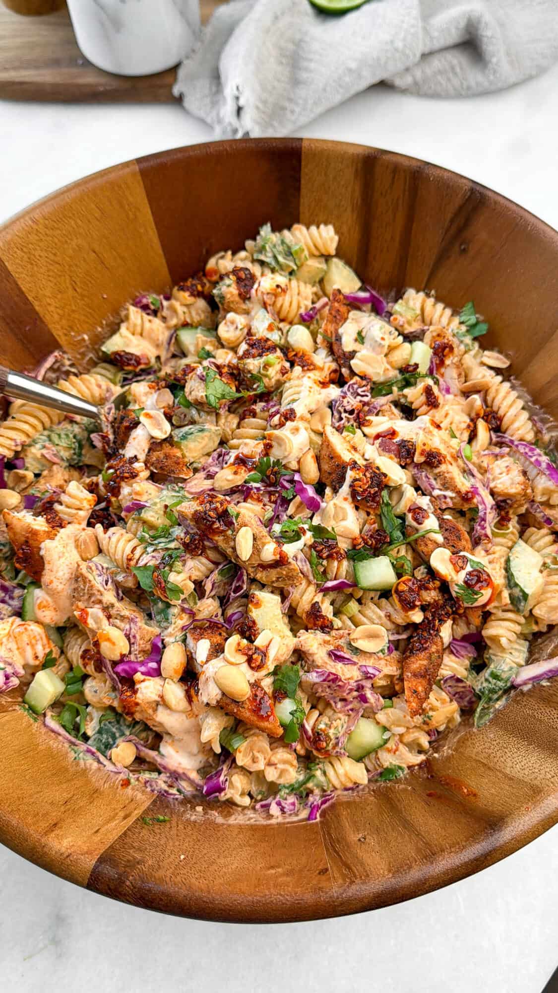 spicy pasta salad in a wood serving bowl
