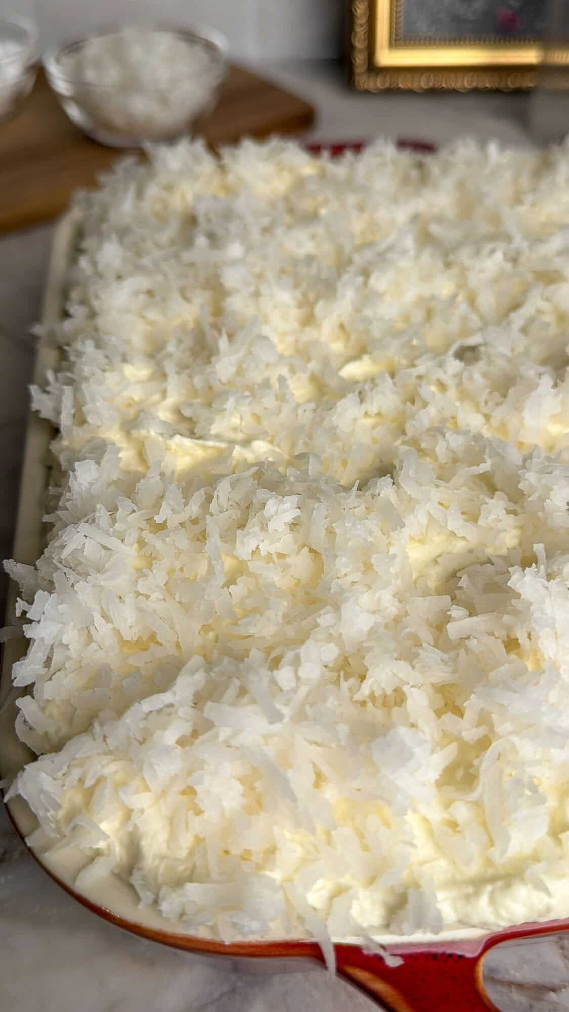 sweetened coconut piled on a coconut cake