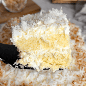 a slice of coconut cake on a spatula