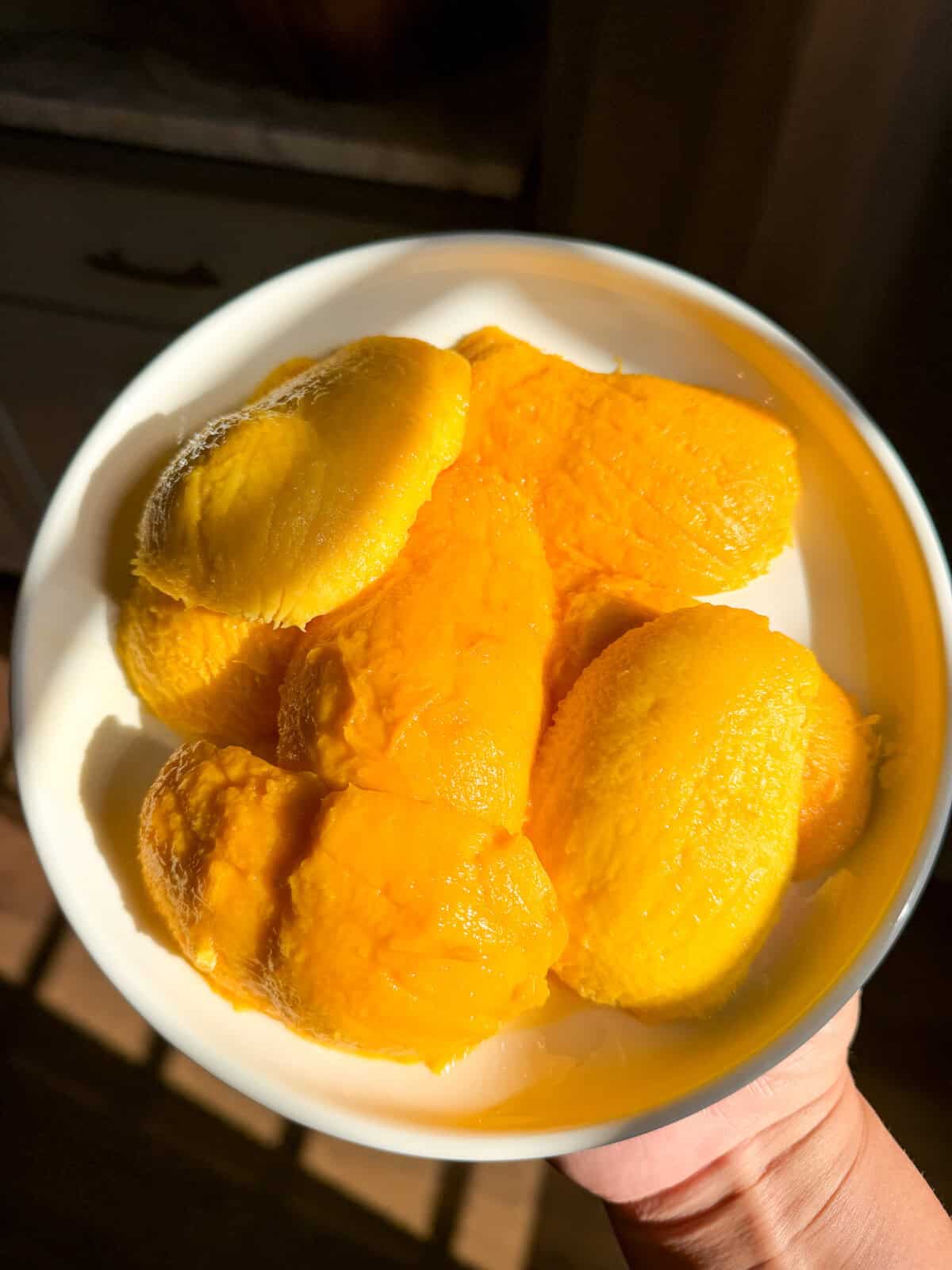 peeled mangos on a plate