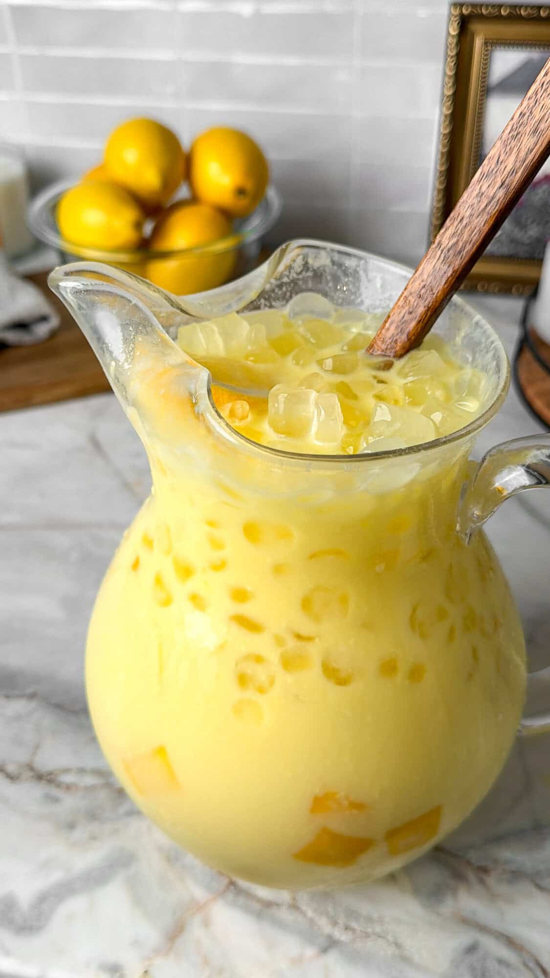 a pitcher filled with mango lemonade