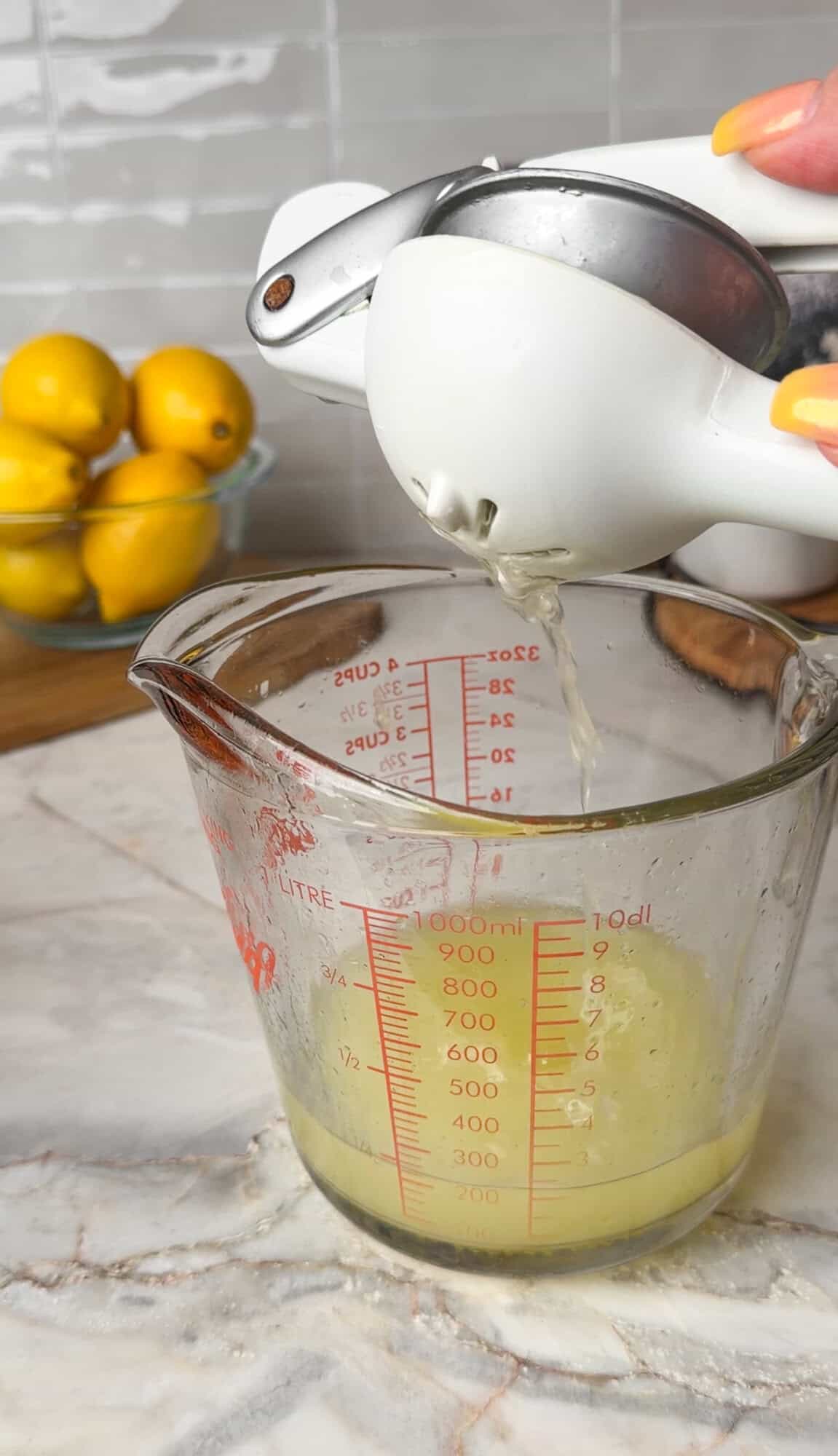 squeezing lemons in a measuring cup