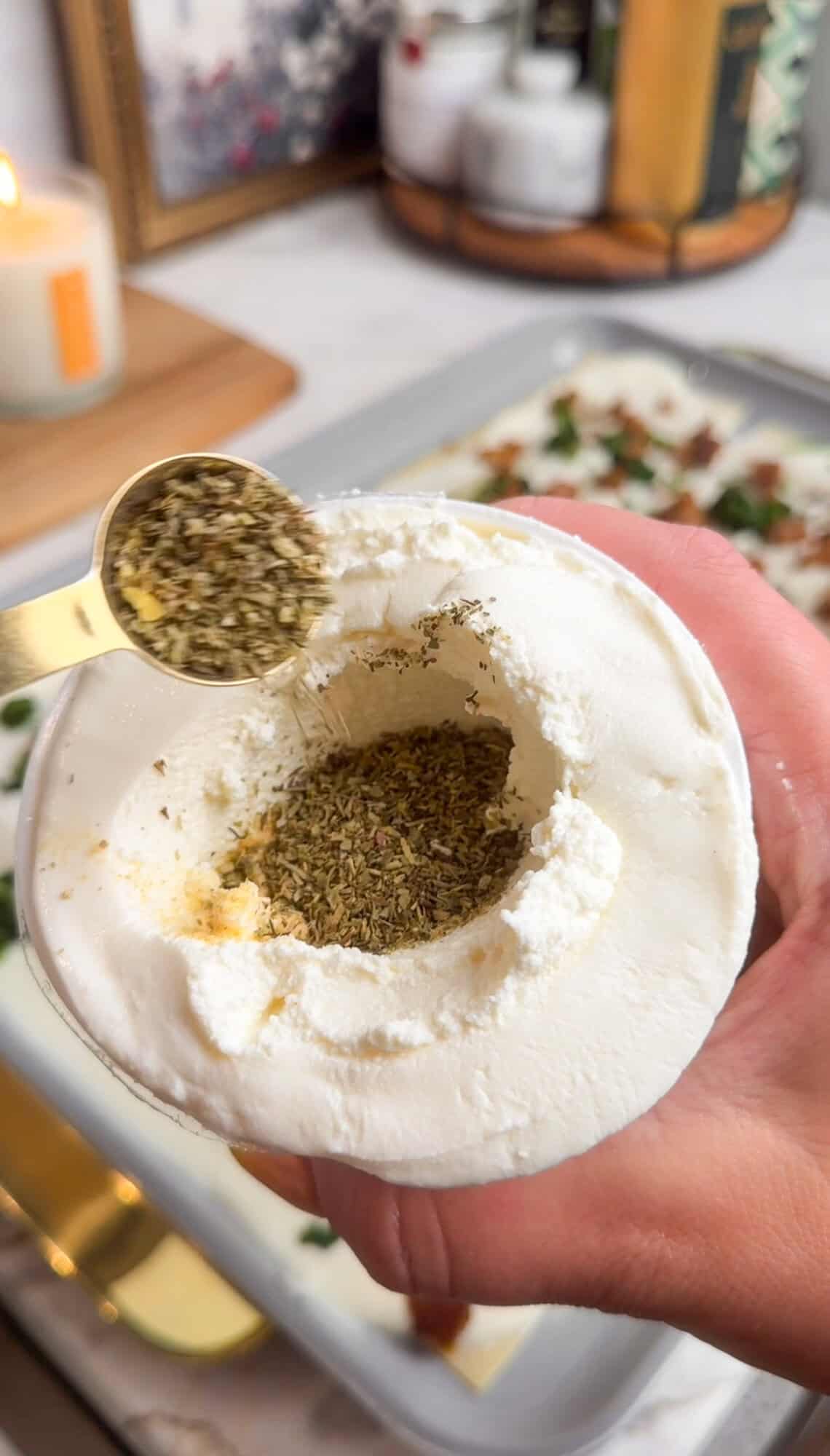 mixing seasonings into the ricotta container