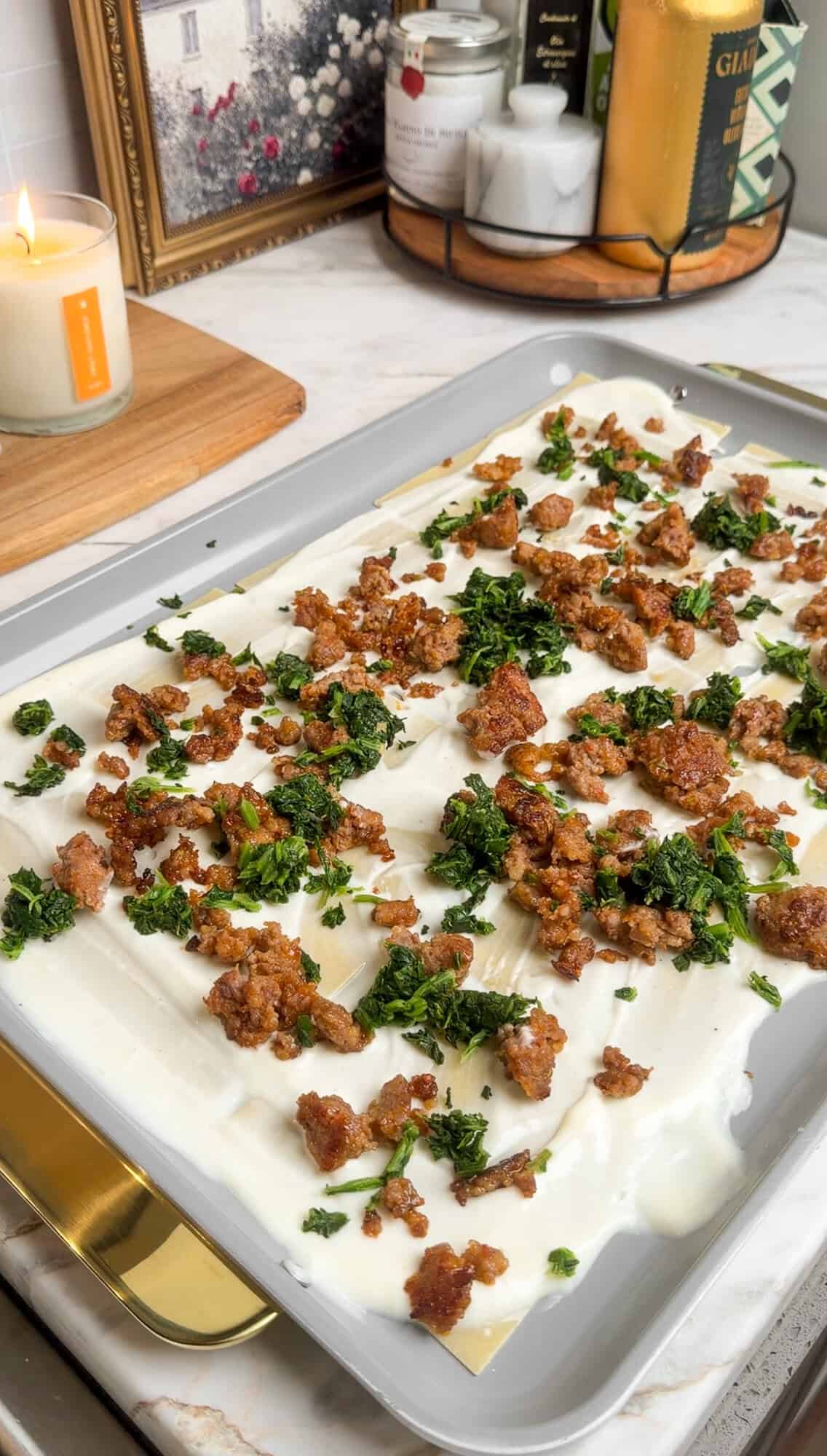 sausage and spinach added to sheet pan lasagna