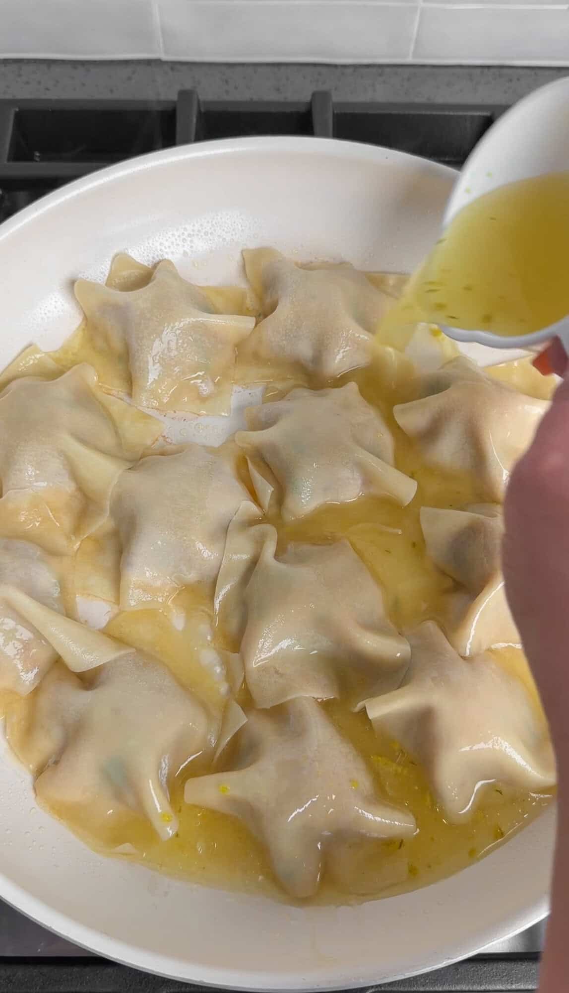 steaming dumplings in chicken stock