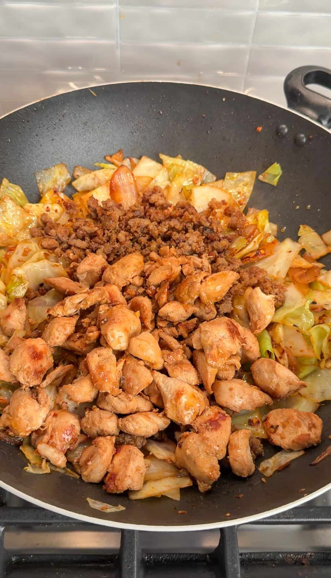 tossing all ingredients together for dirty cabbage with chili oil