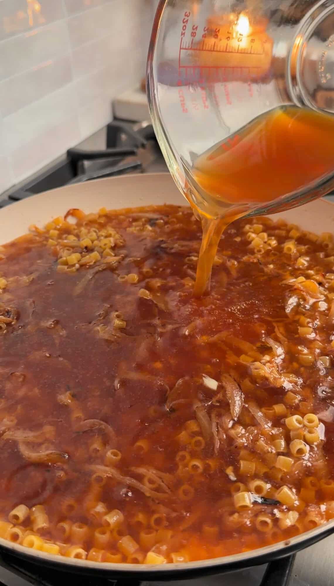 adding beef stock to french onion mac and cheese