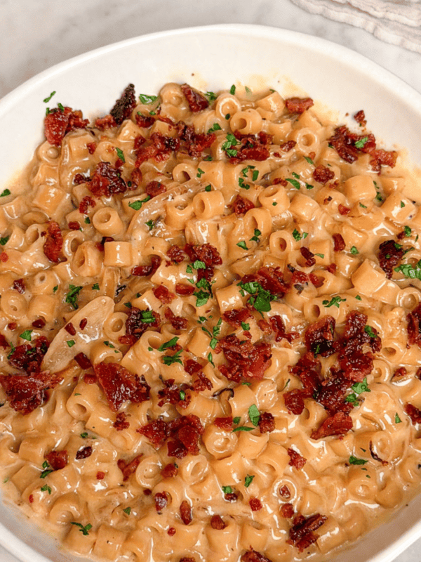a bowl of french onion mac and cheese with bacon