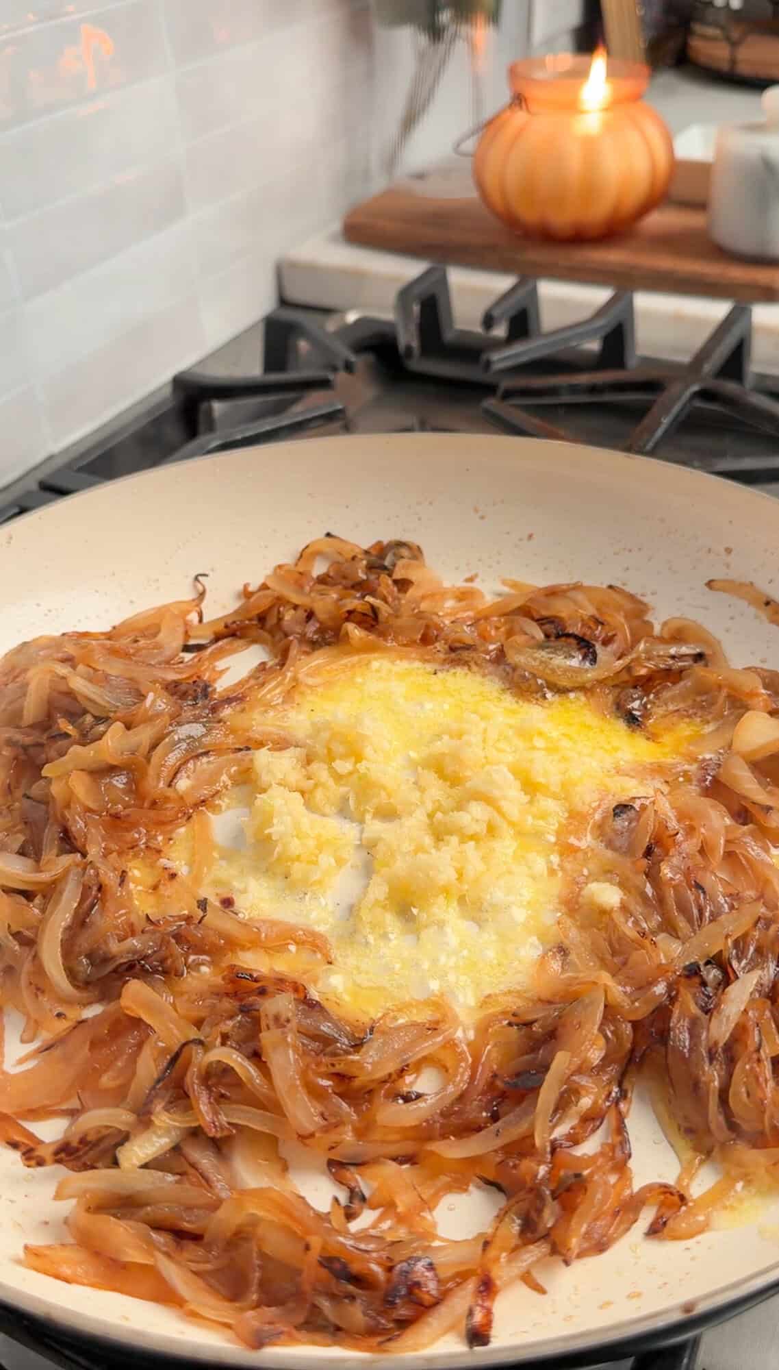 adding butter and garlic to french onion mac and cheese