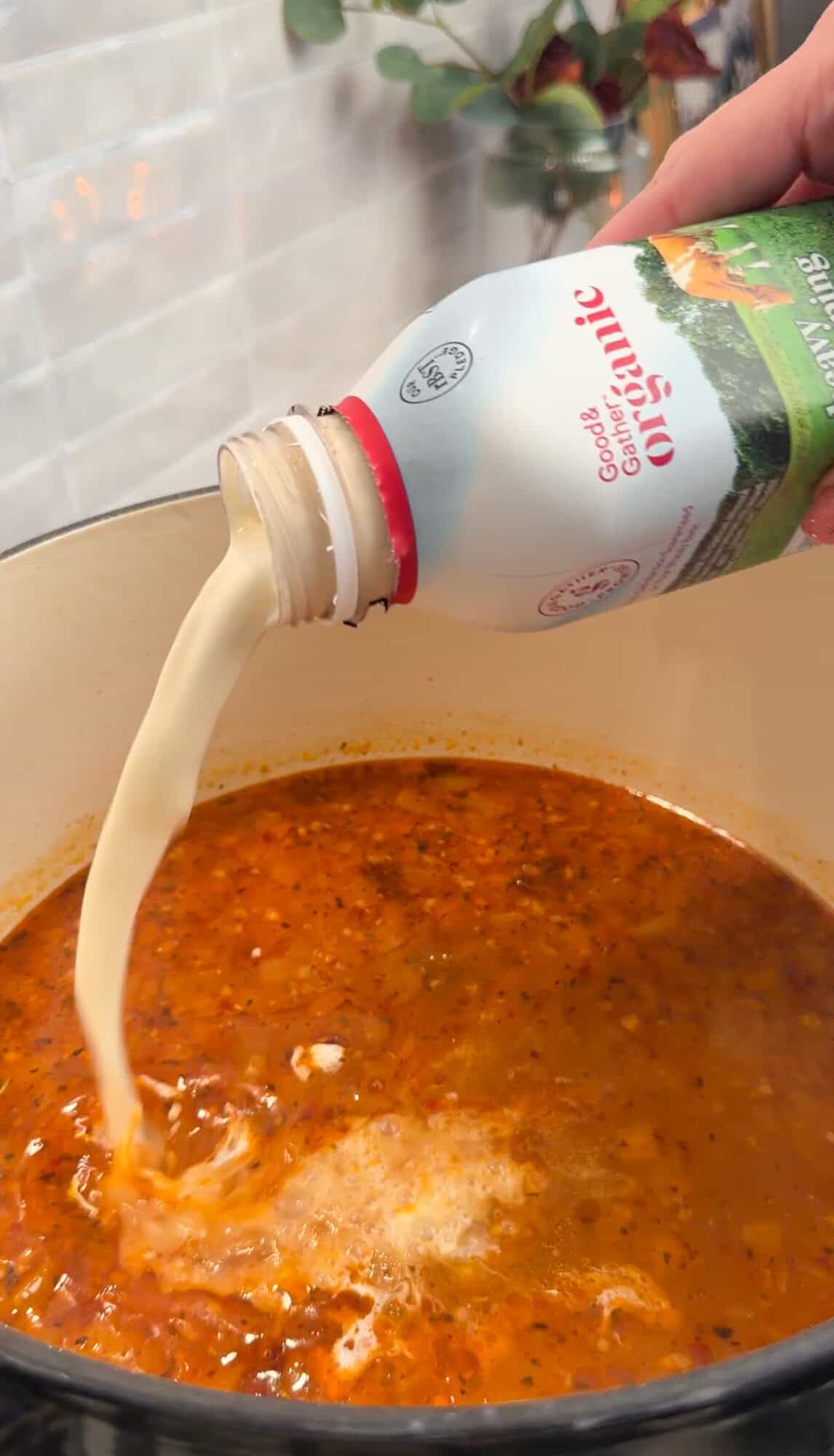 adding cream to the base of sausage gnocchi soup