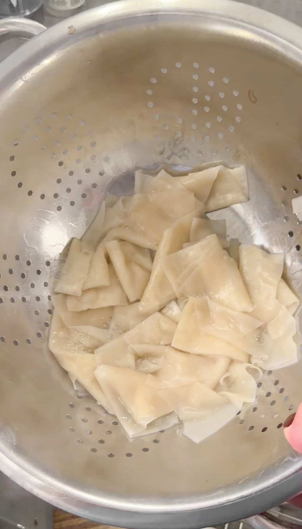 draining wonton wrapper pasta for dirty cabbage