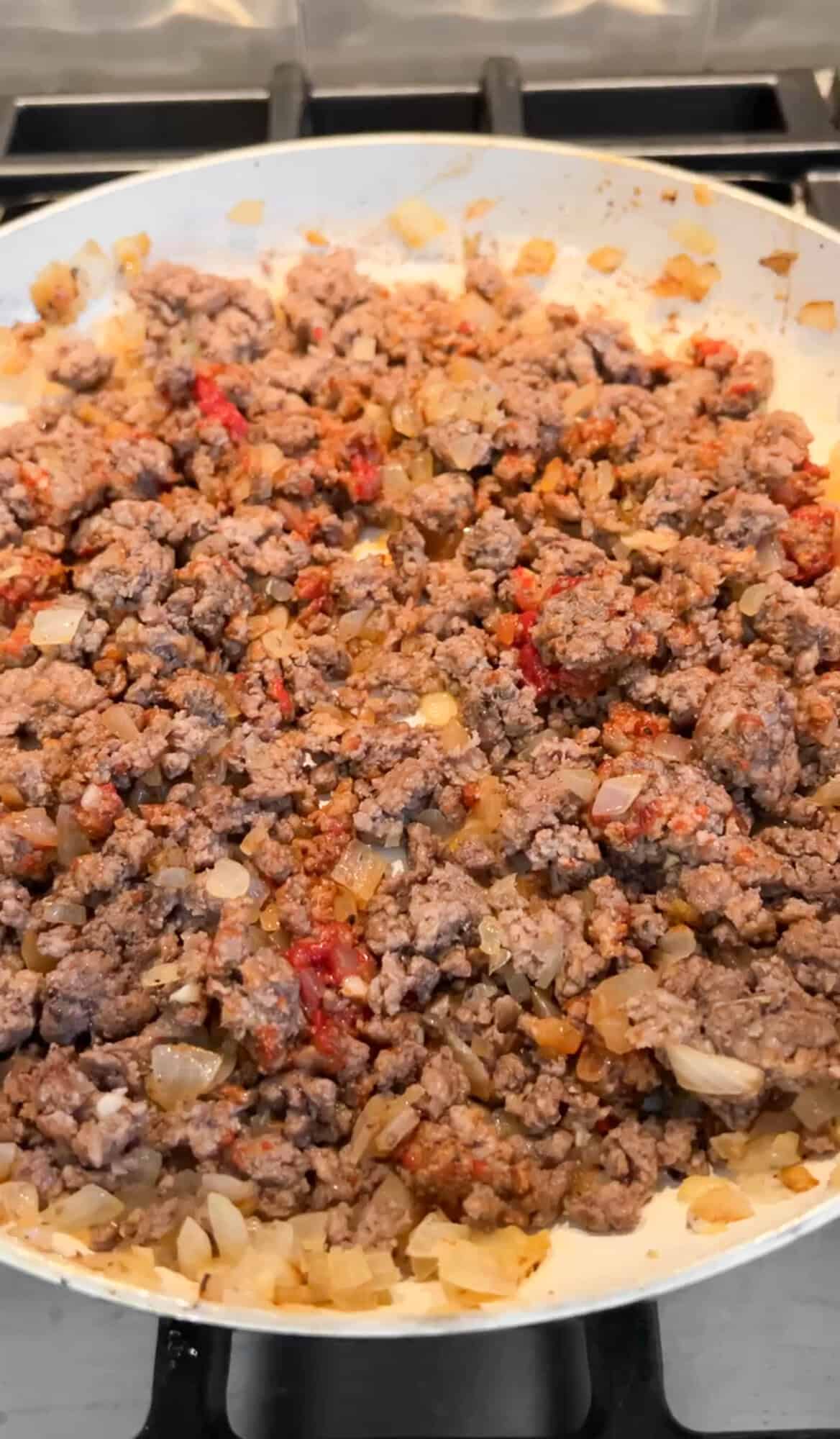 preparing the meat sauce with ground beef and onions