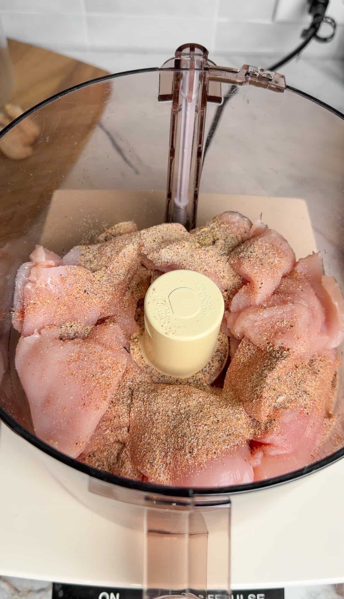 chicken and seasonings in a food processor