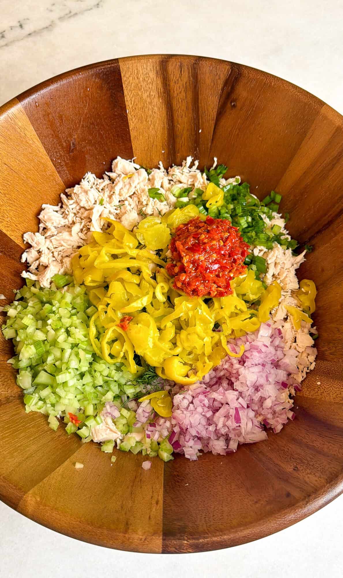 pepperoncini chicken salad ingredients in a bowl