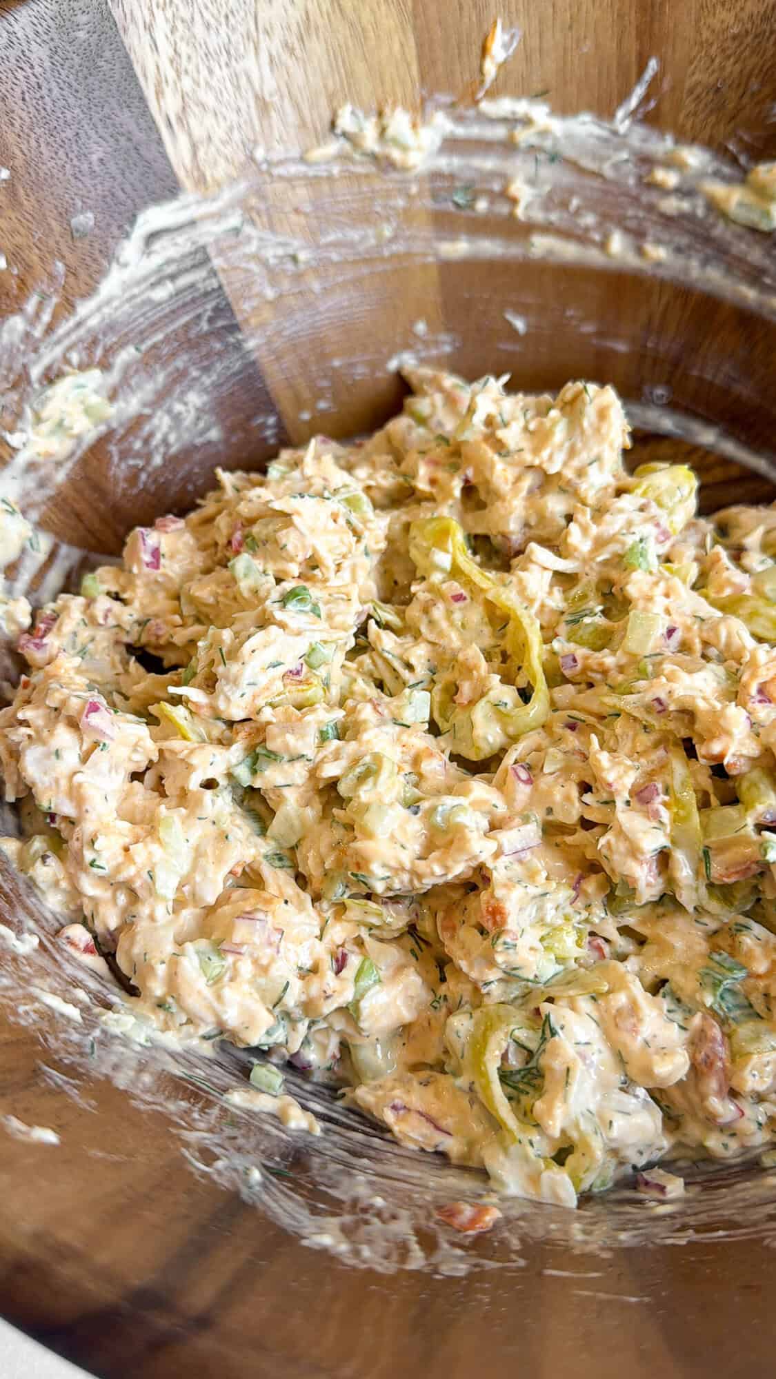 pepperoncini chicken salad ingredients mixed in a bowl