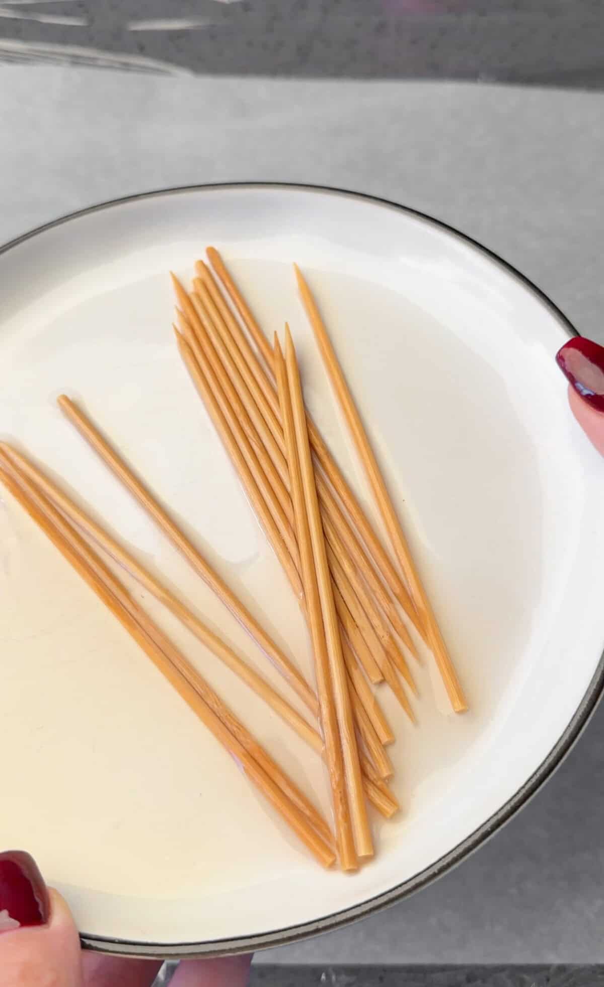 Season and Marinate the Chicken Soaking bamboo skewers in water.