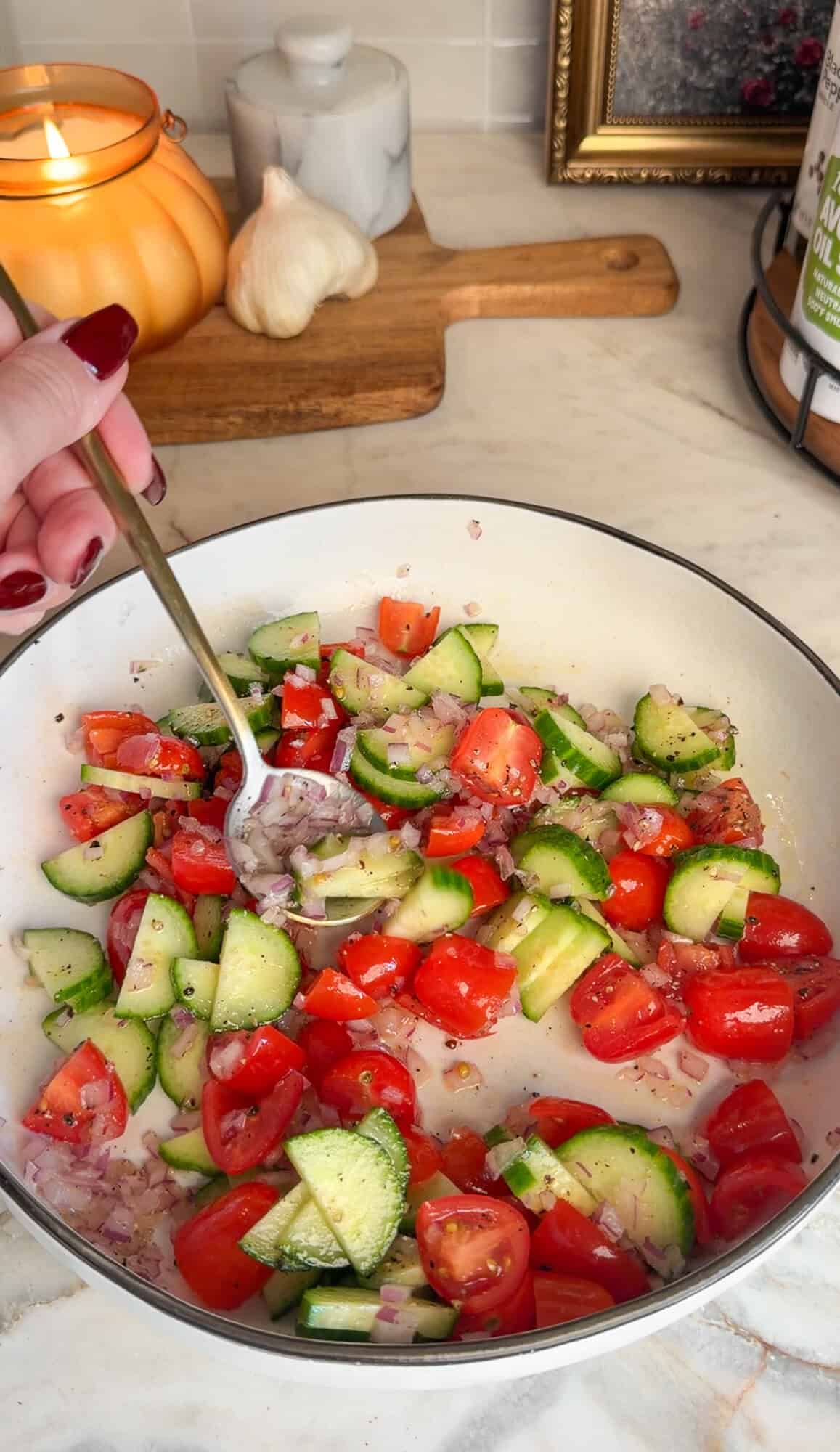 Season and Marinate the Chicken Tomato-cucumber salad for Greek chicken bowls.