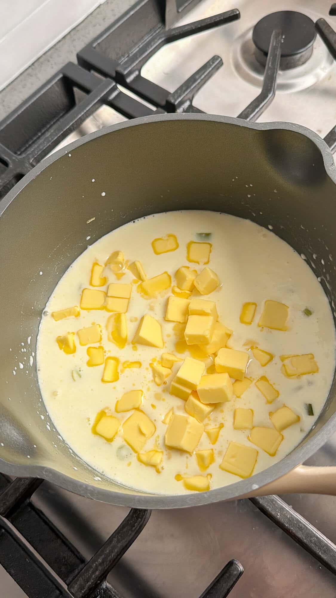 adding cold butter cubes to beurre blanc