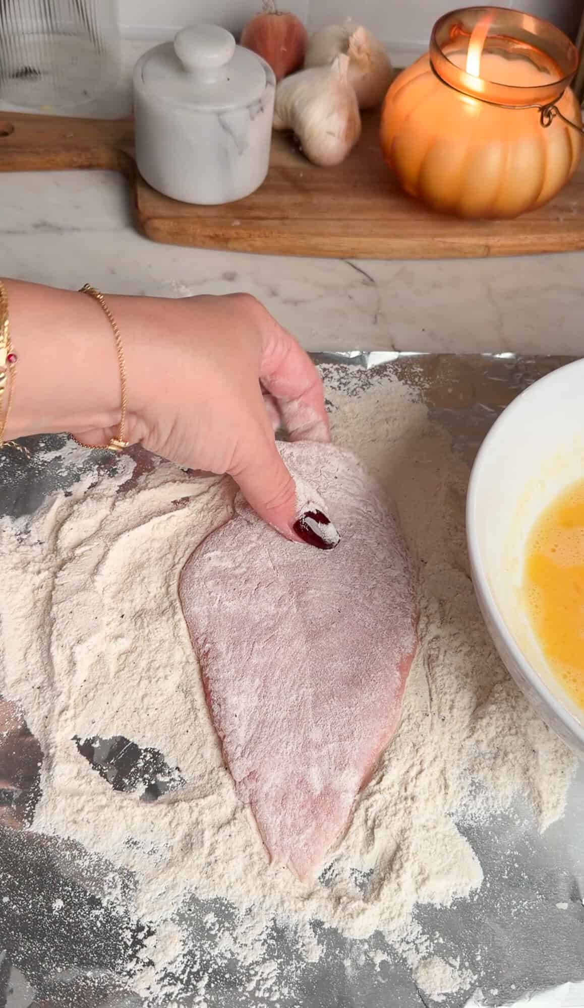 dredging chicken in seasoned flour